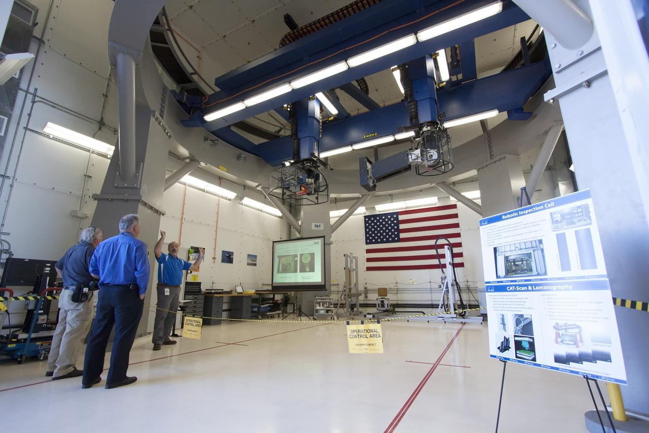 CAPE CANAVERAL, Fla. – Paul Vona, operations engineer, NDT Services, with PaR Systems Inc., demonstrates the automated X-ray system in the robotic inspection cell for members of the media at Hangar N at Cape Canaveral Air Force Station in Florida. PaR Systems held an Open House to celebrate the one-year anniversary of a lease agreement with Kennedy. Under a 15-year lease, PaR Systems is utilizing Hangar N and its unique nondestructive testing equipment.     The partnership agreement was established by Kennedy's Center Planning and Development Directorate. The agreement is just one example of the types of partnerships that Kennedy is seeking to create a multi-user spaceport.  Photo credit: NASA/Cory Huston