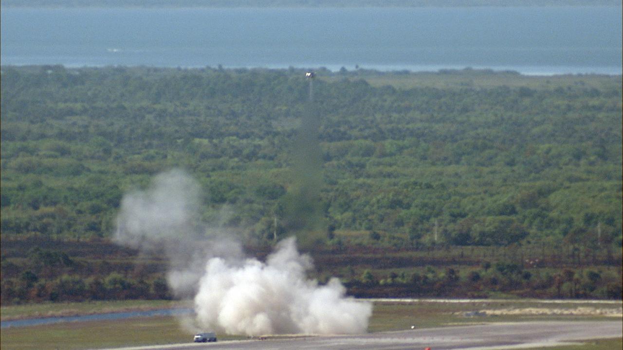 CAPE CANAVERAL, Fla. – NASA's Project Morpheus prototype lander soars high during a free flight test at the north end of the Shuttle Landing Facility at NASA's Kennedy Space Center in Florida. The 96-second test began at 4:21 p.m. EDT with the Morpheus lander launching from the ground over the flame trench at a new launch site and ascending more than 800 feet at a peak speed of 36 mph. The vehicle with its recently installed autonomous landing and hazard avoidance technology, or ALHAT, sensors surveyed the hazard field to determine safe landing sites. Morpheus then flew forward and downward covering 1,300 feet while performing a 78-foot divert to simulate a hazard avoidance maneuver. The lander descended and landed on a dedicated pad inside the ALHAT field. Project Morpheus tests NASA’s ALHAT, and an engine that runs on liquid oxygen and methane, or green propellants, into a fully-operational lander that could deliver cargo to other planetary surfaces.    The landing facility provides the lander with the kind of field necessary for realistic testing, complete with rocks, craters and hazards to avoid. Morpheus’ ALHAT payload allows it to navigate to clear landing sites amidst rocks, craters and other hazards during its descent. Project Morpheus is being managed under the Advanced Exploration Systems, or AES, Division in NASA’s Human Exploration and Operations Mission Directorate. The efforts in AES pioneer new approaches for rapidly developing prototype systems, demonstrating key capabilities and validating operational concepts for future human missions beyond Earth orbit. For more information on Project Morpheus, visit http://morpheuslander.jsc.nasa.gov/.  Photo credit: NASA/Frankie Martin