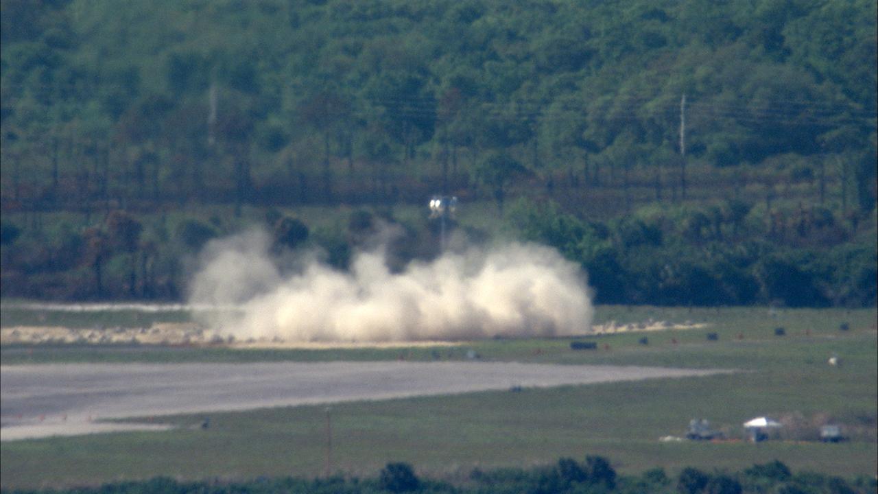 CAPE CANAVERAL, Fla. – NASA's Project Morpheus prototype lander begins its descent toward the autonomous landing and hazard avoidance technology, or ALHAT, hazard field after a free flight test at the north end of the Shuttle Landing Facility at NASA's Kennedy Space Center in Florida. The 96-second test began at 4:21 p.m. EDT with the Morpheus lander launching from the ground over the flame trench at a new launch site and ascending more than 800 feet at a peak speed of 36 mph. The vehicle with its recently installed autonomous landing and hazard avoidance technology, or ALHAT, sensors surveyed the hazard field to determine safe landing sites. Morpheus then flew forward and downward covering 1,300 feet while performing a 78-foot divert to simulate a hazard avoidance maneuver. The lander descended and landed on a dedicated pad inside the ALHAT field. Project Morpheus tests NASA’s ALHAT, and an engine that runs on liquid oxygen and methane, or green propellants, into a fully-operational lander that could deliver cargo to other planetary surfaces.    The landing facility provides the lander with the kind of field necessary for realistic testing, complete with rocks, craters and hazards to avoid. Morpheus’ ALHAT payload allows it to navigate to clear landing sites amidst rocks, craters and other hazards during its descent. Project Morpheus is being managed under the Advanced Exploration Systems, or AES, Division in NASA’s Human Exploration and Operations Mission Directorate. The efforts in AES pioneer new approaches for rapidly developing prototype systems, demonstrating key capabilities and validating operational concepts for future human missions beyond Earth orbit. For more information on Project Morpheus, visit http://morpheuslander.jsc.nasa.gov/.  Photo credit: NASA/Frankie Martin