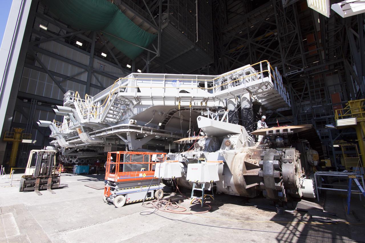 CAPE CANAVERAL, Fla. – Inside the Vehicle Assembly Building at NASA’s Kennedy Space Center in Florida, preparations are underway to remove the gear boxes on the C truck of crawler-transporter 2, or CT-2. A section of the treads were removed to allow access to the gear boxes.    Work continues in high bay 2 to upgrade CT-2. The modifications are designed to ensure CT-2’s ability to transport launch vehicles currently in development, such as the agency’s Space Launch System, to the launch pad. The Ground Systems Development and Operations Program office at Kennedy is overseeing the upgrades. For more than 45 years the crawler-transporters were used to transport the mobile launcher platform and the Apollo-Saturn V rockets and, later, space shuttles to Launch Pads 39A and B. For more information, visit: http://www.nasa.gov/exploration/systems/ground/crawler-transporter. Photo credit: NASA/Cory Huston