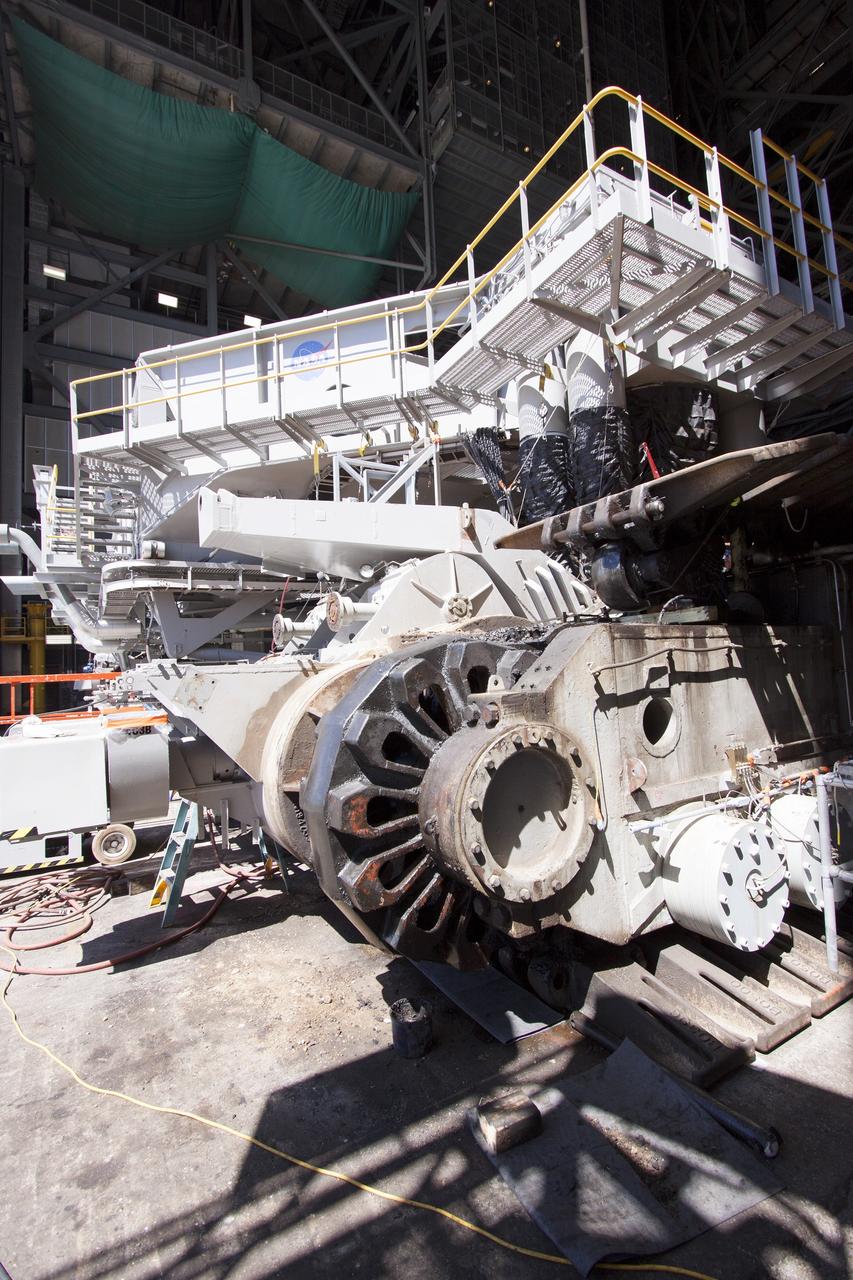 CAPE CANAVERAL, Fla. – Inside the Vehicle Assembly Building at NASA’s Kennedy Space Center in Florida, preparations are underway to remove the gear boxes on the C truck of crawler-transporter 2, or CT-2. A section of the treads were removed to allow access to the gear boxes.    Work continues in high bay 2 to upgrade CT-2. The modifications are designed to ensure CT-2’s ability to transport launch vehicles currently in development, such as the agency’s Space Launch System, to the launch pad. The Ground Systems Development and Operations Program office at Kennedy is overseeing the upgrades. For more than 45 years the crawler-transporters were used to transport the mobile launcher platform and the Apollo-Saturn V rockets and, later, space shuttles to Launch Pads 39A and B. For more information, visit: http://www.nasa.gov/exploration/systems/ground/crawler-transporter. Photo credit: NASA/Cory Huston