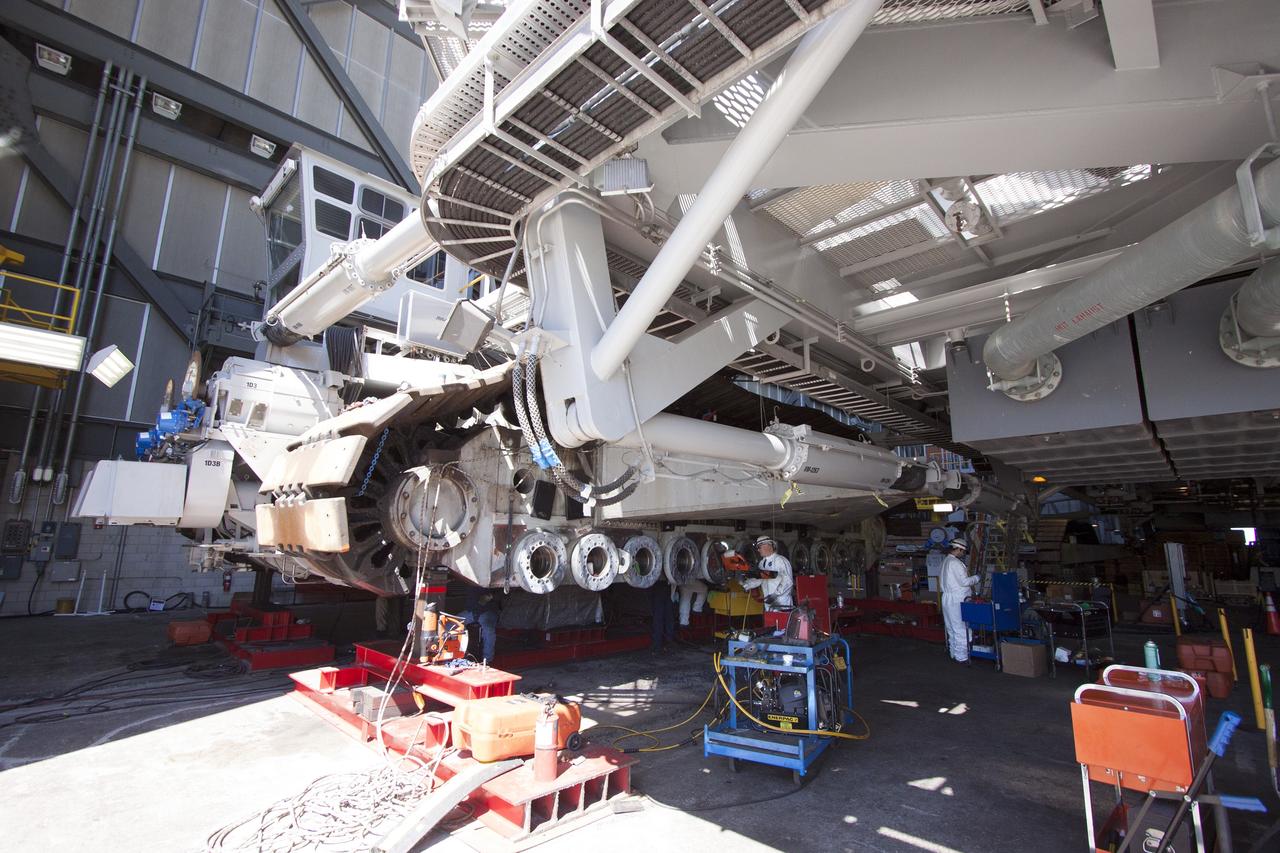 CAPE CANAVERAL, Fla. – Inside the Vehicle Assembly Building at NASA’s Kennedy Space Center in Florida, ground support technicians install new roller bearings on the C truck of crawler-transporter 2, or CT-2.     Work continues in high bay 2 to upgrade CT-2. The modifications are designed to ensure CT-2’s ability to transport launch vehicles currently in development, such as the agency’s Space Launch System, to the launch pad. The Ground Systems Development and Operations Program office at Kennedy is overseeing the upgrades. For more than 45 years the crawler-transporters were used to transport the mobile launcher platform and the Apollo-Saturn V rockets and, later, space shuttles to Launch Pads 39A and B. For more information, visit: http://www.nasa.gov/exploration/systems/ground/crawler-transporter. Photo credit: NASA/Cory Huston