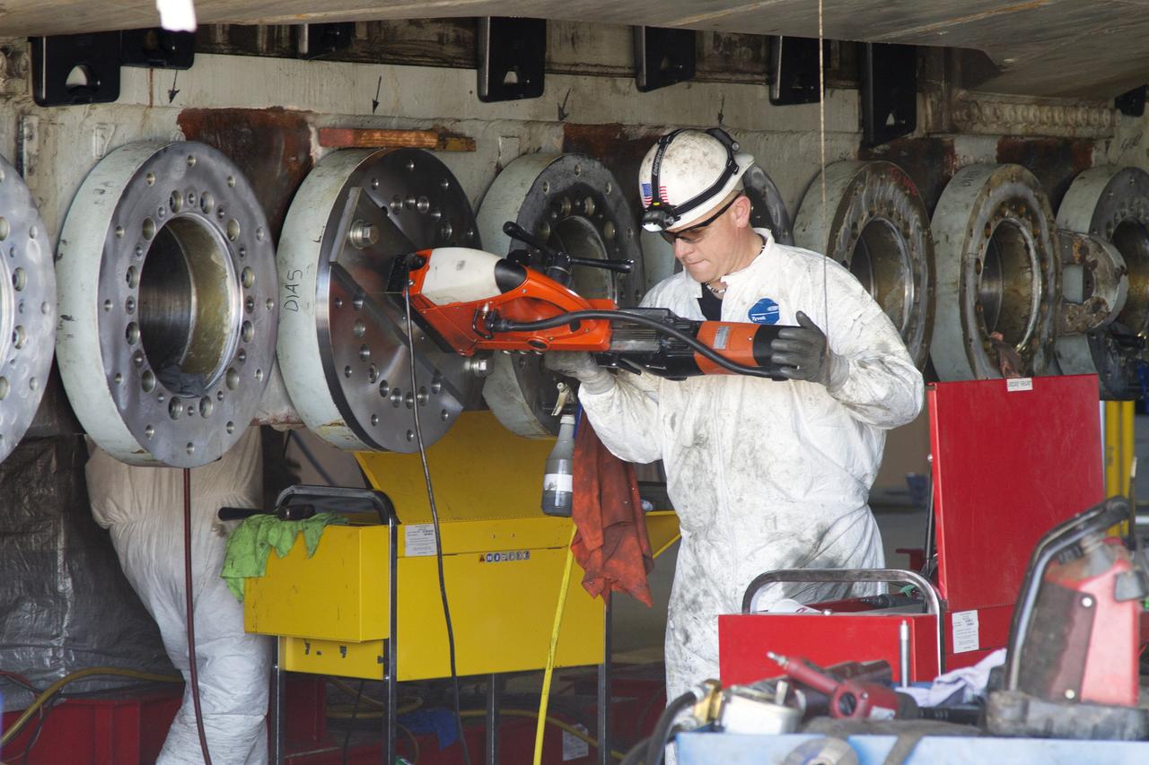 CAPE CANAVERAL, Fla. – Inside the Vehicle Assembly Building at NASA’s Kennedy Space Center in Florida, a ground support technician installs a new roller bearing on the C truck of crawler-transporter 2, or CT-2.     Work continues in high bay 2 to upgrade CT-2. The modifications are designed to ensure CT-2’s ability to transport launch vehicles currently in development, such as the agency’s Space Launch System, to the launch pad. The Ground Systems Development and Operations Program office at Kennedy is overseeing the upgrades. For more than 45 years the crawler-transporters were used to transport the mobile launcher platform and the Apollo-Saturn V rockets and, later, space shuttles to Launch Pads 39A and B. For more information, visit: http://www.nasa.gov/exploration/systems/ground/crawler-transporter. Photo credit: NASA/Cory Huston