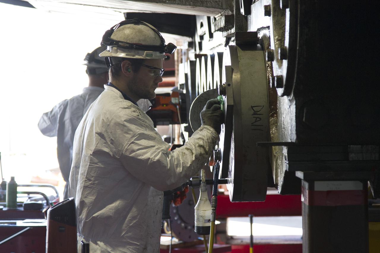 CAPE CANAVERAL, Fla. – Inside the Vehicle Assembly Building at NASA’s Kennedy Space Center in Florida, ground support technicians install new roller bearings on the C truck of crawler-transporter 2, or CT-2.     Work continues in high bay 2 to upgrade CT-2. The modifications are designed to ensure CT-2’s ability to transport launch vehicles currently in development, such as the agency’s Space Launch System, to the launch pad. The Ground Systems Development and Operations Program office at Kennedy is overseeing the upgrades. For more than 45 years the crawler-transporters were used to transport the mobile launcher platform and the Apollo-Saturn V rockets and, later, space shuttles to Launch Pads 39A and B. For more information, visit: http://www.nasa.gov/exploration/systems/ground/crawler-transporter. Photo credit: NASA/Cory Huston