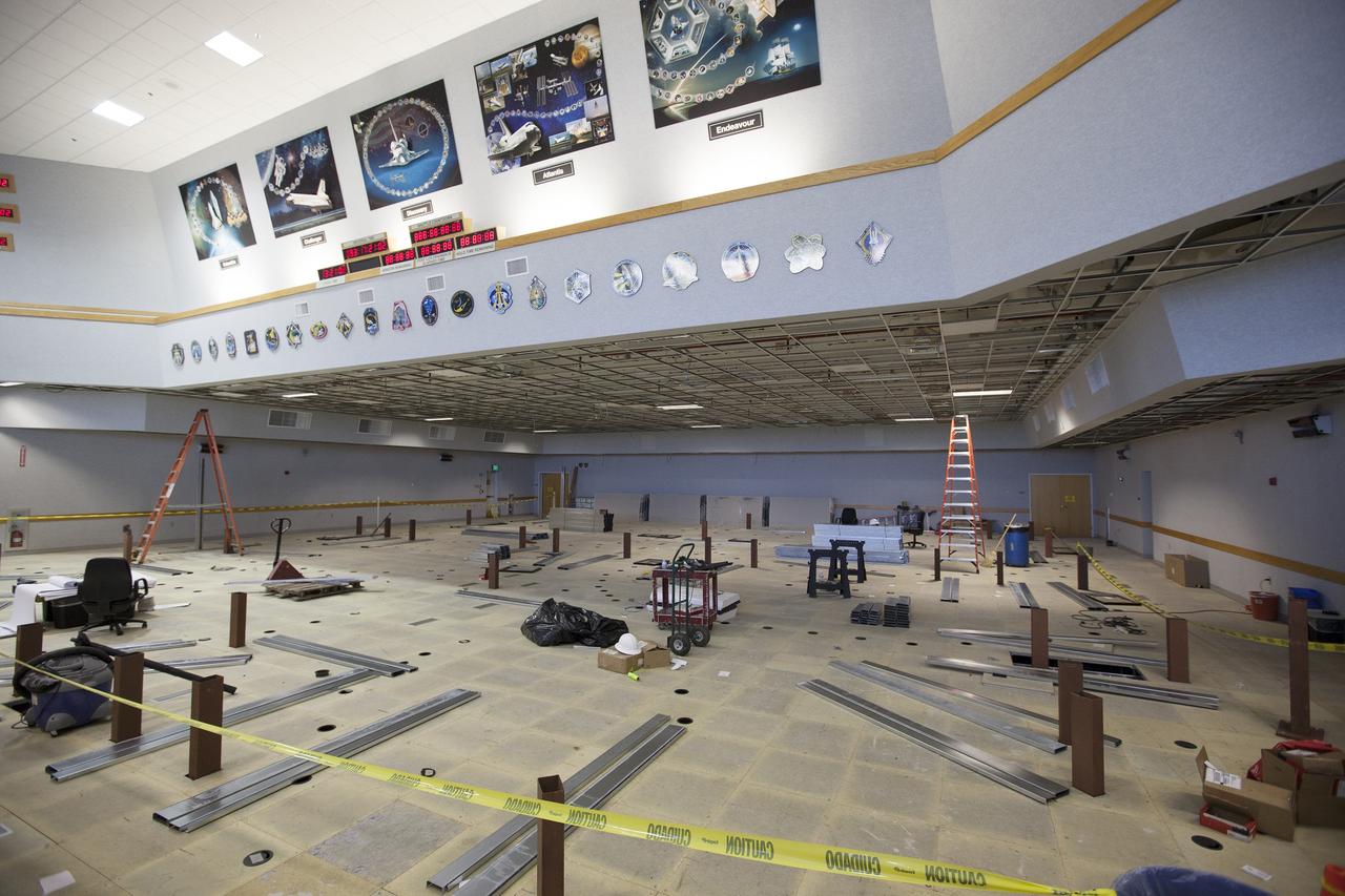 CAPE CANAVERAL, Fla. – The Ground Systems Development and Operations Program is overseeing efforts to create a new multi-user firing room in Firing Room 4 in the Launch Control Center at NASA's Kennedy Space Center in Florida. The main floor consoles, cabling and wires below the floor and ceiling tiles above have been removed. Sub-flooring has been installed and the room is marked off to create four separate rooms on the main floor. In view along the soffit are space shuttle launch plaques for 21 missions launched from Firing Room 4.    The design of Firing Room 4 will incorporate five control room areas that are flexible to meet current and future NASA and commercial user requirements. The equipment and most of the consoles from Firing Room 4 were moved to Firing Room 2 for possible future reuse. Photo credit: NASA/Ben Smegelsky