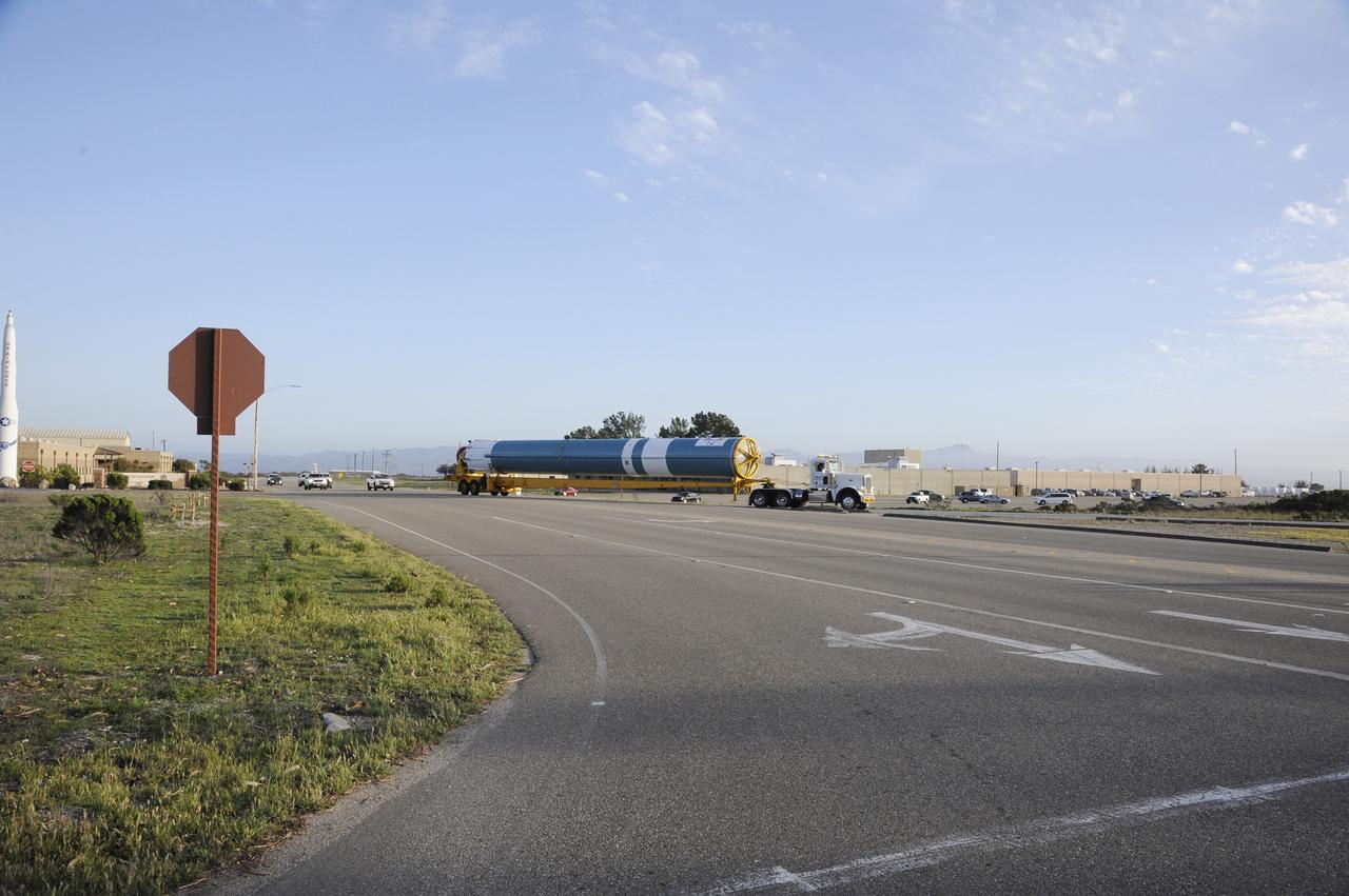 VANDENBERG AIR FORCE BASE, Calif. – The Delta first-stage booster for NASA's Orbiting Carbon Observatory-2 mission, or OCO-2, passes a static display of a U.S. Air Force Minuteman III intercontinental ballistic missile, at left, on its move from the Building 836 hangar to the Horizontal Processing Facility at Space Launch Complex 2 on Vandenberg Air Force Base in California.    OCO-2 is scheduled to launch aboard a United Launch Alliance Delta II rocket on July 1, 2014.  The observatory will collect precise global measurements of carbon dioxide in the Earth's atmosphere and provide scientists with a better idea of the chemical compound's impacts on climate change. Scientists will analyze this data to improve our understanding of the natural processes and human activities that regulate the abundance and distribution of this important atmospheric gas. To learn more about OCO-2, visit http://oco.jpl.nasa.gov.  Photo credit: NASA/D. Liberotti, 30th Space Wing, VAFB