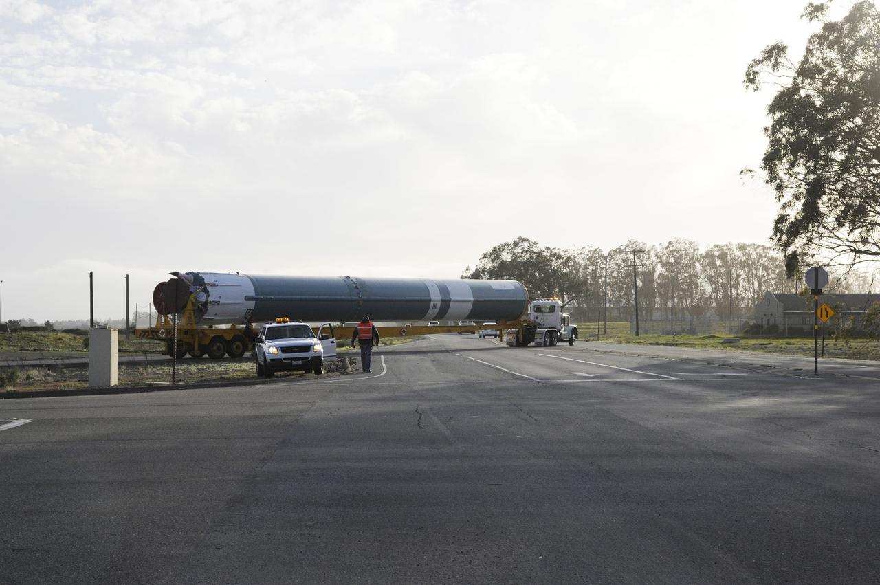 VANDENBERG AIR FORCE BASE, Calif. – The Delta first-stage booster for NASA's Orbiting Carbon Observatory-2 mission, or OCO-2, makes its way past a security guard as it travels along the roads at Vandenberg Air Force Base in California on its move from the Building 836 hangar to the Horizontal Processing Facility at Space Launch Complex 2.    OCO-2 is scheduled to launch aboard a United Launch Alliance Delta II rocket on July 1, 2014.  The observatory will collect precise global measurements of carbon dioxide in the Earth's atmosphere and provide scientists with a better idea of the chemical compound's impacts on climate change. Scientists will analyze this data to improve our understanding of the natural processes and human activities that regulate the abundance and distribution of this important atmospheric gas. To learn more about OCO-2, visit http://oco.jpl.nasa.gov.  Photo credit: NASA/D. Liberotti, 30th Space Wing, VAFB