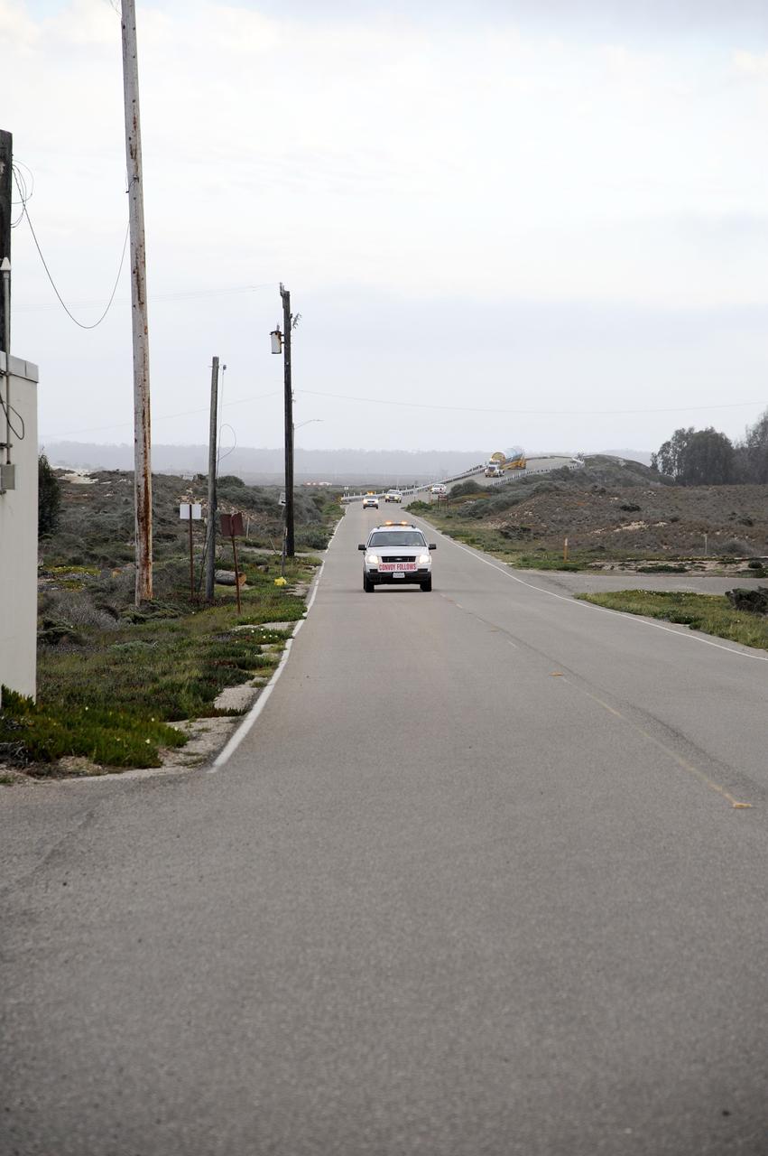 VANDENBERG AIR FORCE BASE, Calif. – The Delta first-stage booster for NASA's Orbiting Carbon Observatory-2 mission, or OCO-2, negotiates an overpass behind its escort vehicles as it makes its way through the roads on Vandenberg Air Force Base in California on its transfer from the Building 836 hangar to the Horizontal Processing Facility at Space Launch Complex 2.    OCO-2 is scheduled to launch aboard a United Launch Alliance Delta II rocket on July 1, 2014.  The observatory will collect precise global measurements of carbon dioxide in the Earth's atmosphere and provide scientists with a better idea of the chemical compound's impacts on climate change. Scientists will analyze this data to improve our understanding of the natural processes and human activities that regulate the abundance and distribution of this important atmospheric gas. To learn more about OCO-2, visit http://oco.jpl.nasa.gov.  Photo credit: NASA/D. Liberotti, 30th Space Wing, VAFB