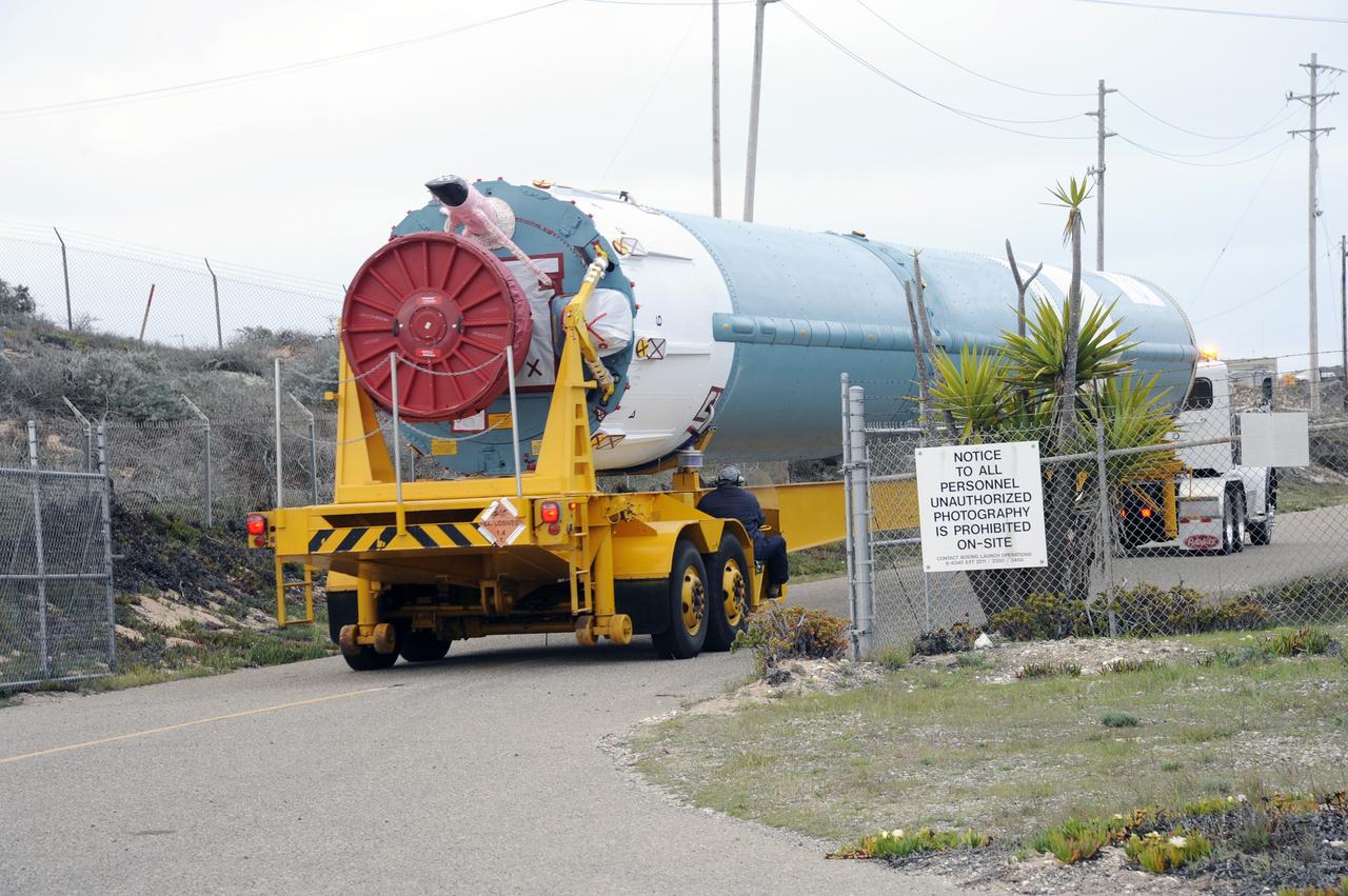 VANDENBERG AIR FORCE BASE, Calif. – The Delta first-stage booster for NASA's Orbiting Carbon Observatory-2 mission, or OCO-2, passes through the fence surrounding the Horizontal Processing Facility at Space Launch Complex 2 on Vandenberg Air Force Base in California.    OCO-2 is scheduled to launch aboard a United Launch Alliance Delta II rocket on July 1, 2014.  The observatory will collect precise global measurements of carbon dioxide in the Earth's atmosphere and provide scientists with a better idea of the chemical compound's impacts on climate change. Scientists will analyze this data to improve our understanding of the natural processes and human activities that regulate the abundance and distribution of this important atmospheric gas. To learn more about OCO-2, visit http://oco.jpl.nasa.gov.  Photo credit: NASA/D. Liberotti, 30th Space Wing, VAFB