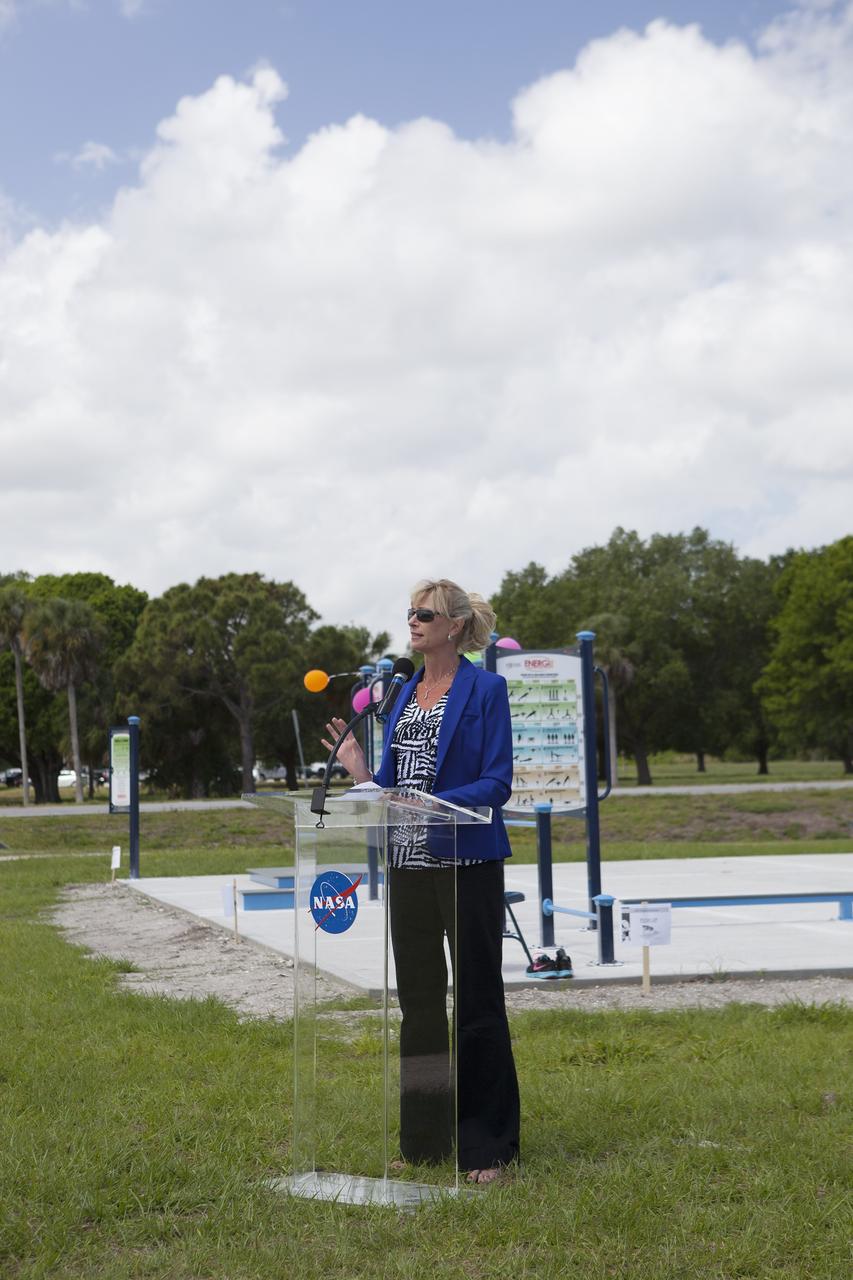 CAPE CANAVERAL, Fla. - Director of Center Operations Nancy Bray welcomes the employees who turned out during their lunchtime for a ribbon-cutting ceremony opening the new fitness trail next to the Space Station Processing Facility at NASA's Kennedy Space Center in Florida. The one-mile-long track will provide employees with a safe place off Kennedy's roadways to walk or run. The more than 6 tons of green waste removed to create the trail's footprint will be mulched and used for cover at Kennedy's landfill. Approximately 1,594 tons of crawler fines -- ground-up crawler rock removed from the crawlerway in the Launch Complex 39 area -- was used for the foundation of the trail. Fitness equipment has been ordered and will be installed on a concrete slab at the trail's west end. After the equipment has been installed, the slab will be coated to provide a rubberized exercise pad. At Kennedy Space Center, the health and safety of every employee is paramount. To learn more about Kennedy, visit http://www.nasa.gov/kennedy. Photo credit: NASA/Frankie Martin