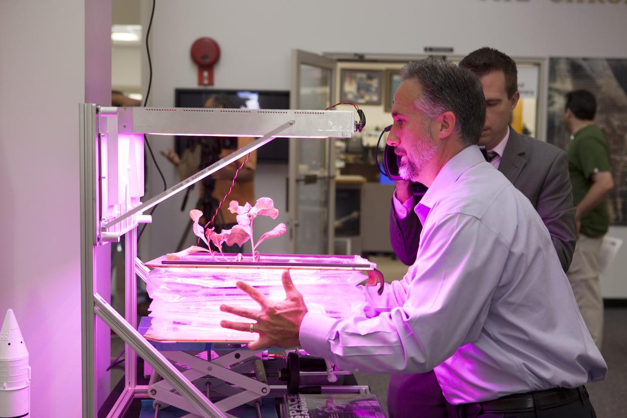 CAPE CANAVERAL, Fla. – At the News Center at NASA's Kennedy Space Center in Florida, Trent Smith of the agency's International Space Station Research and Utilization Office, discusses the Vegetable Production System "VEGGIE" experiment being launched to the ISS. This investigation will focus on the growth and development of "Outredgeous" Lettuce seedlings in the microgravity environment of space and its effects on composition of microbial flora in the Veggie facility. Plans call for lettuce plants to be harvested in-orbit, frozen and returned to the ground for post-flight evaluation.      Scheduled for launch on April 14, 2014 atop a Falcon 9 rocket, Dragon spacecraft will be marking its fourth trip to the space station. The SpaceX-3 mission carrying almost 2.5 tons of supplies, technology and science experiments is the third of 12 flights contracted by NASA to resupply the orbiting laboratory. For more information, visit http://www.nasa.gov/mission_pages/station/structure/launch/index.html Photo credit: NASA/Kim Shiflett