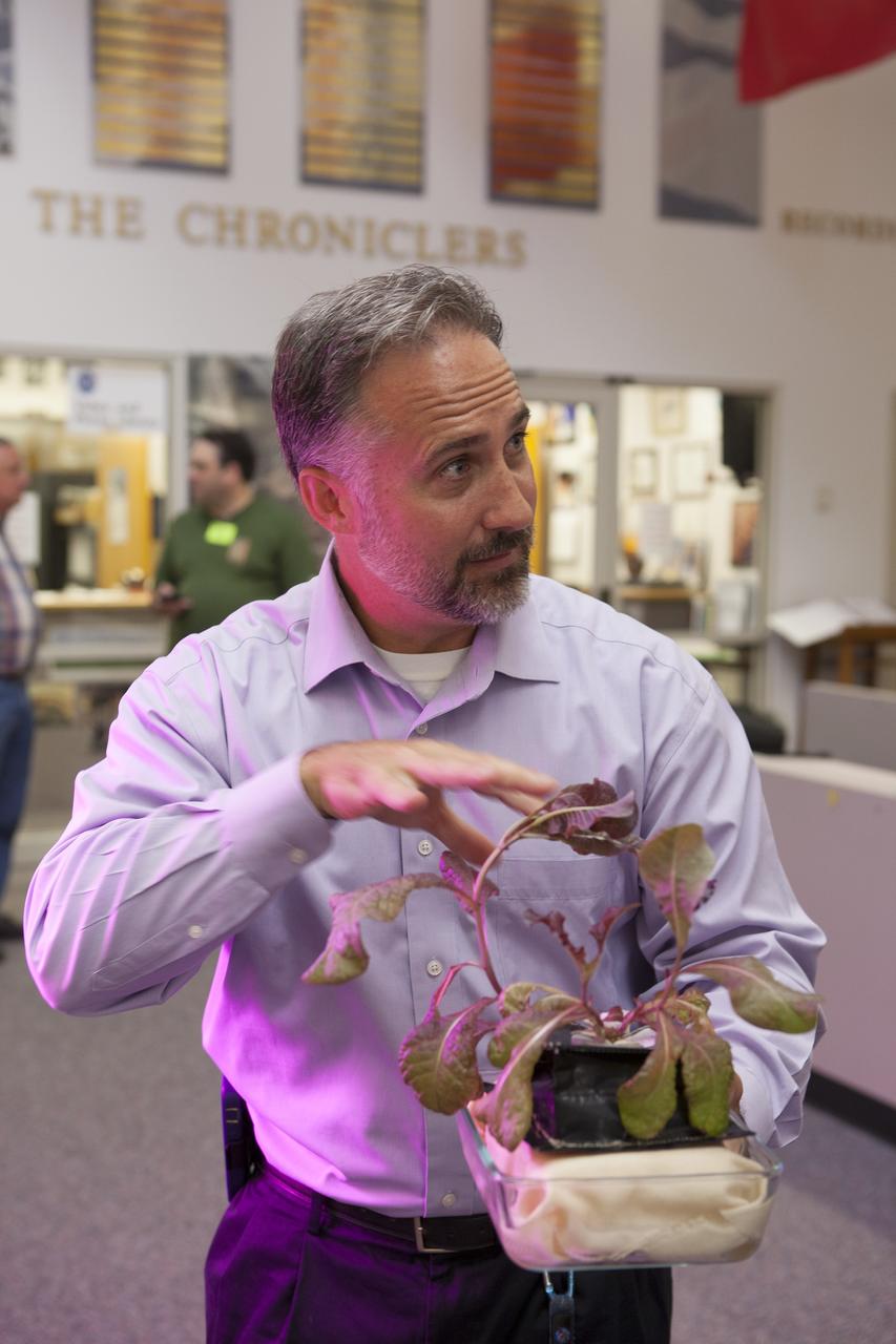 CAPE CANAVERAL, Fla. – At the News Center at NASA's Kennedy Space Center in Florida, Trent Smith of the agency's International Space Station Research and Utilization Office, discusses the Vegetable Production System "VEGGIE" experiment being launched to the ISS. This investigation will focus on the growth and development of "Outredgeous" Lettuce seedlings in the microgravity environment of space and its effects on composition of microbial flora in the Veggie facility. Plans call for lettuce plants to be harvested in-orbit, frozen and returned to the ground for post-flight evaluation.      Scheduled for launch on April 14, 2014 atop a Falcon 9 rocket, Dragon spacecraft will be marking its fourth trip to the space station. The SpaceX-3 mission carrying almost 2.5 tons of supplies, technology and science experiments is the third of 12 flights contracted by NASA to resupply the orbiting laboratory. For more information, visit http://www.nasa.gov/mission_pages/station/structure/launch/index.html Photo credit: NASA/Kim Shiflett
