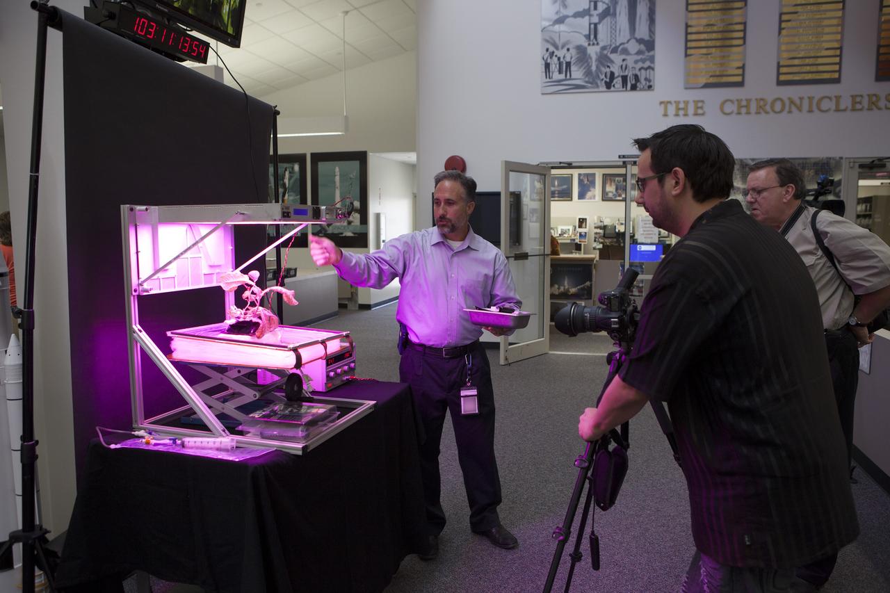 CAPE CANAVERAL, Fla. – At the News Center at NASA's Kennedy Space Center in Florida, Trent Smith of the agency's International Space Station Research and Utilization Office, discusses the Vegetable Production System "VEGGIE" experiment being launched to the ISS. This investigation will focus on the growth and development of "Outredgeous" Lettuce seedlings in the microgravity environment of space and its effects on composition of microbial flora in the Veggie facility. Plans call for lettuce plants to be harvested in-orbit, frozen and returned to the ground for post-flight evaluation.      Scheduled for launch on April 14, 2014 atop a Falcon 9 rocket, Dragon spacecraft will be marking its fourth trip to the space station. The SpaceX-3 mission carrying almost 2.5 tons of supplies, technology and science experiments is the third of 12 flights contracted by NASA to resupply the orbiting laboratory. For more information, visit http://www.nasa.gov/mission_pages/station/structure/launch/index.html Photo credit: NASA/Kim Shiflett
