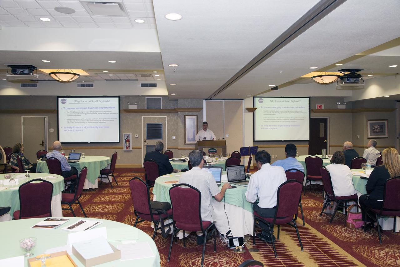 CAPE CANAVERAL, Fla. -- At the Marriott Courtyard Hotel in Cocoa Beach, Fla., Greg Clements, chief of Kennedy's Control and Data Systems Division and lead for the Engineering and Technology's Small Payload Integrated Testing Services, or SPLITS, line of business, speaks to participants in the 4th International Workshop on Lunar and Planetary Compact and Cryogenic Science and Technology Applications.    Scientists, engineers and entrepreneurs interested in research on the moon and other planetary surfaces, recently participated in the Workshop. Taking place April 8-11, 2014, the event was designed to foster collaborative work among those interested in solving the challenges of building hardware, software and businesses interested in going back to the moon and exploring beyond. Photo credit: NASA/Daniel Casper