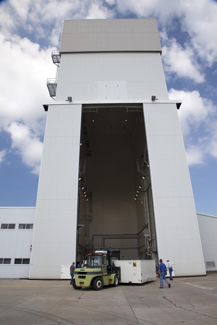 CAPE CANAVERAL, Fla. - Containers carrying the first set of Ogive panels for the Orion Launch Abort System aretransferred into the Launch Abort System Facility at NASA’s Kennedy Space Center in Florida. During processing, the Ogive panels will enclose and protect the Orion spacecraft and attach to the Launch Abort System. Orion is the exploration spacecraft designed to carry astronauts to destinations not yet explored by humans, including an asteroid and Mars. It will have emergency abort capability, sustain the crew during space travel and provide safe re-entry from deep space return velocities. The first unpiloted test flight of Orion is scheduled to launch in 2014 atop a Delta IV rocket and in 2017 on NASA’s Space Launch System rocket. For more information, visit www.nasa.gov/orion. Photo credit: Daniel Casper