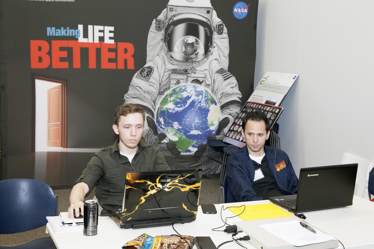CAPE CANAVERAL, Fla. - Astronaut Resource Managing System team members Sam Neblett of KSC Technik Inc., left, and Roberto Ricci participate in the International Space Apps Challenge in the Center for Space Education at the Kennedy Space Center Visitor Complex in Florida.       Kennedy Space Center hosted one of the over 90 locations around the world where participants congregated for the attempt to design innovative solutions for global challenges over a 48-hour period. This year's development marathon focused on five NASA mission areas: Asteroids, Earth Watch, Human Spaceflight, Robotics, and Technology in Space. Three of this year’s challenges were developed by KSC employees: Space Wearables: Fashion Designer to Astronauts, Growing Food for a Martian Table, and Asteroid Prospector. The winners selected in 2014 at Kennedy were Astronaut Resource Managing System, or ARMS, for Best Use of Data and SpaceWear for Best Use of Hardware. ARMS also took the People's Choice Award. For more information, visit https://2014.spaceappschallenge.org.  Photo credit: NASA/Daniel Casper