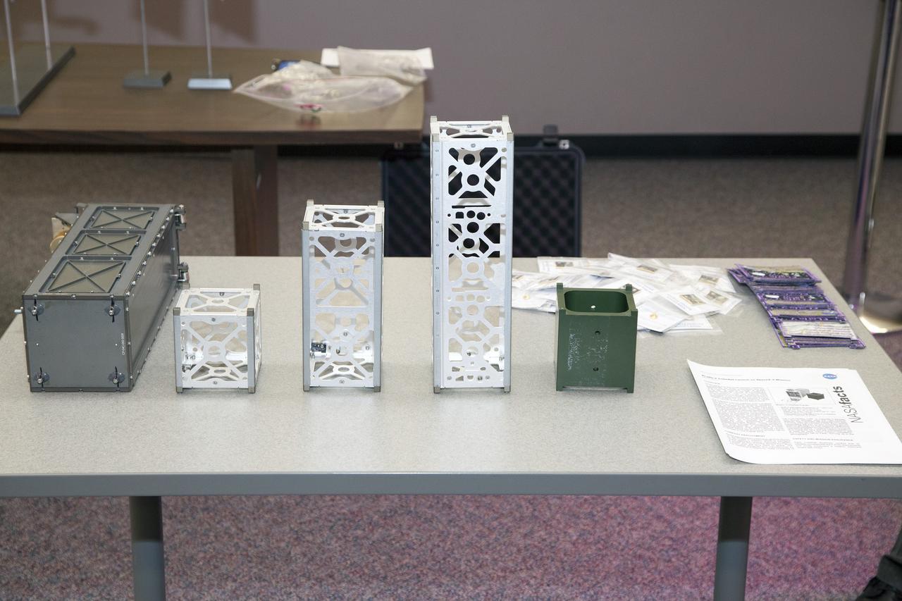 CAPE CANAVERAL, Fla. - Models of the hardware used to support the CubeSats flying on the ELaNa V mission are displayed in the NASA Newsroom at Kennedy Space Center in Florida. At left is a model of the Poly-Picosatellite Orbital Deployer, or P-POD, next to models of the various CubeSat canisters.     NASA selected five small research satellites, or CubeSats, for the ELaNa V mission launching on SpaceX-3. Four P-PODs aboard the SpaceX Falcon 9 rocket will ferry them to space. The CubeSats were designed by three universities and the agency's Ames Research Center in California. Launch is scheduled at about 4:58 p.m. EDT April 14. The SpaceX-3 mission, carrying almost 2.5 tons of supplies, technology and science experiments, is the third of 12 flights under NASA's Commercial Resupply Services contract to resupply the orbiting laboratory. For more information about NASA's CubeSat Launch Initiative, visit http://go.nasa.gov/CubeSat_initiative. Photo credit: NASA/Glenn Benson