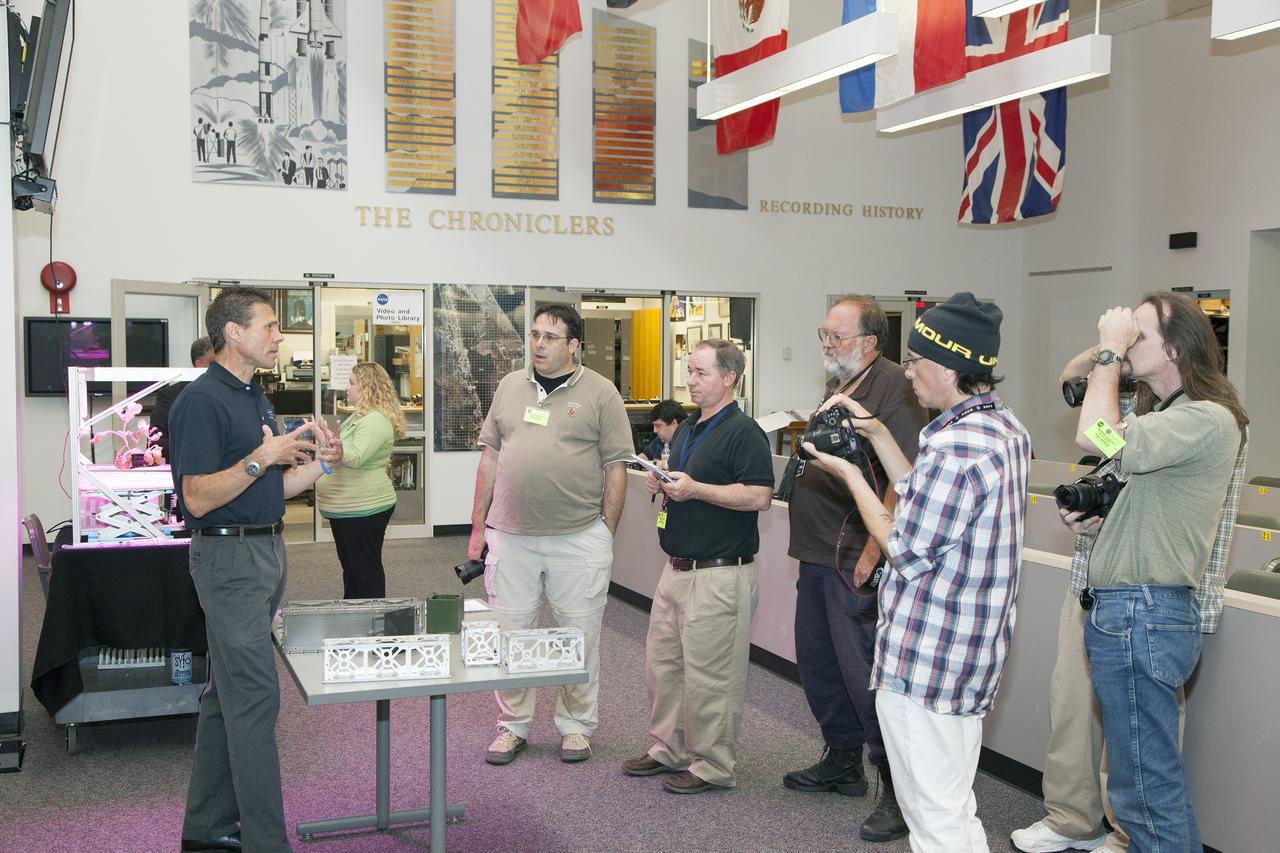 CAPE CANAVERAL, Fla. - Scott Higginbotham, left, mission manager for ELaNa V, discusses the concepts behind the design and deployment of the CubeSats flying on the ELaNa V mission with media representatives in the NASA Newsroom at Kennedy Space Center in Florida, using models of the Poly-Picosatellite Orbital Deployer, or P-POD, and various CubeSat canisters.     NASA selected five small research satellites, or CubeSats, for the ELaNa V mission launching on SpaceX-3. Four P-PODs aboard the SpaceX Falcon 9 rocket will ferry them to space. The CubeSats were designed by three universities and the agency's Ames Research Center in California. Launch is scheduled at about 4:58 p.m. EDT April 14. The SpaceX-3 mission, carrying almost 2.5 tons of supplies, technology and science experiments, is the third of 12 flights under NASA's Commercial Resupply Services contract to resupply the orbiting laboratory. For more information about NASA's CubeSat Launch Initiative, visit http://go.nasa.gov/CubeSat_initiative. Photo credit: NASA/Glenn Benson