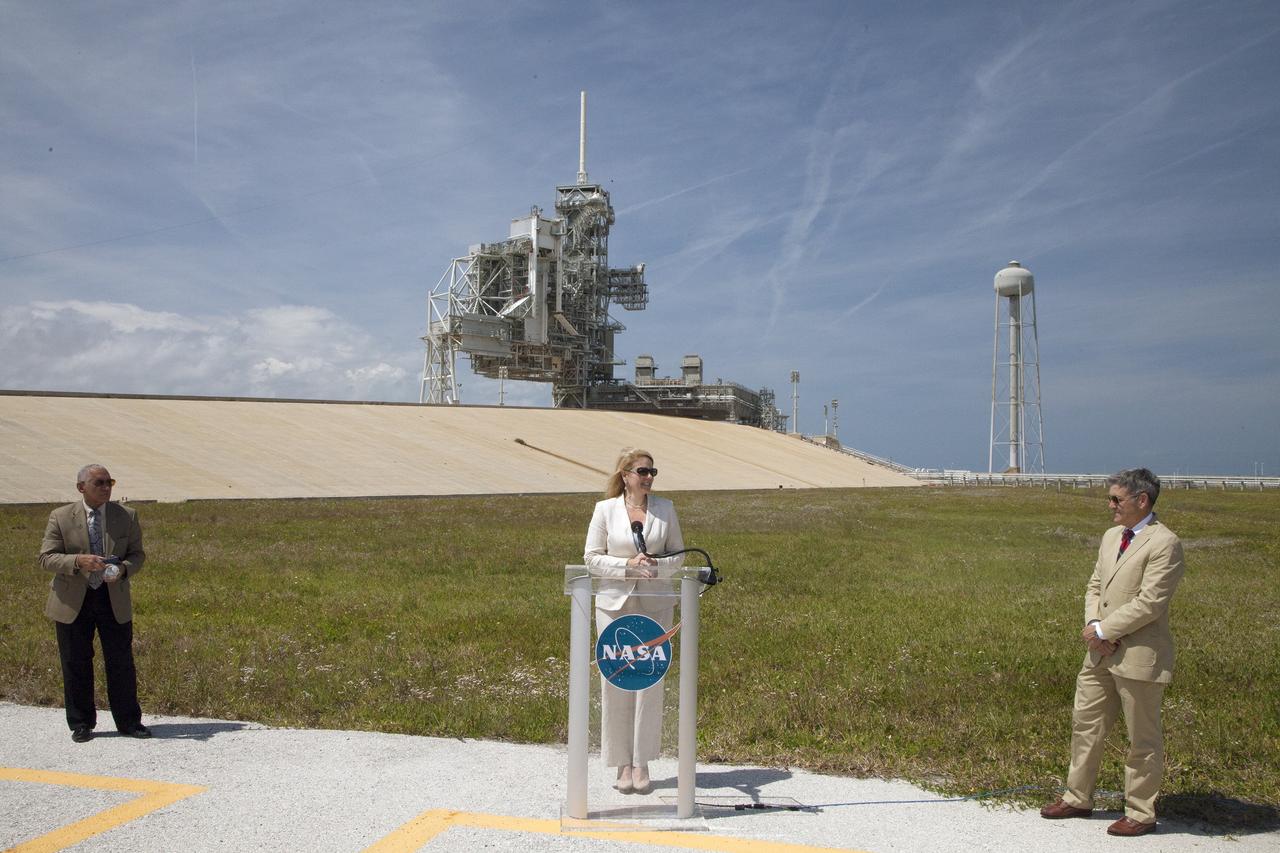 CAPE CANAVERAL, Fla. -- At Kennedy Space Center's Launch Pad 39A, Gwynne Shotwell, president and chief operating officer of Space Exploration Technologies SpaceX of Hawthorne, Calif., announces that NASA has just signed a lease agreement with SpaceX for use and operation of Launch Complex 39A. NASA Administrator Charlie Bolden, left, and Kennedy Space Center Director Bob Cabana listen.      SpaceX will use Launch Complex 39A for rockets such as the Falcon Heavy, currently under development. Both launch pad 39A and 39B were originally built for the Apollo/Saturn V rockets that launched American astronauts on their historic journeys to the moon and later modified to support the 30-year shuttle program. Pad 39B is now being modified by NASA to support the Space Launch System SLS rocket boosting the Orion spacecraft part of the agency’s plan to explore beyond low-Earth orbit. To learn more about Launch Pad 39A visit: http://www.nasa.gov/mission_pages/shuttle/launch/launch-complex39-toc.html Photo credit: NASA/Dan Casper