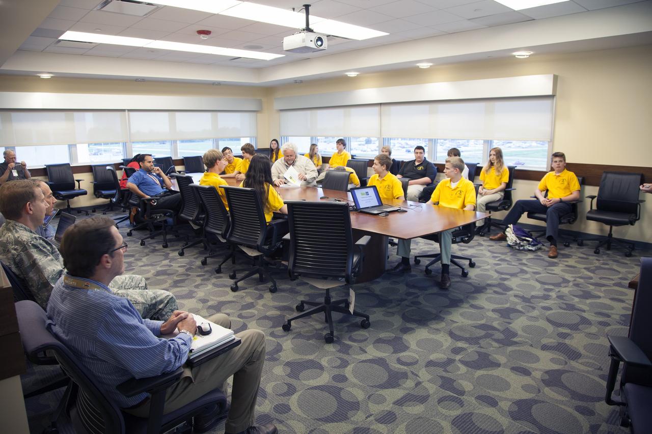 CAPE CANAVERAL, Fla. – Merritt Island High School students and their NASA mentors participate in a Critical Design Review of StangSat concepts in the Operations and Checkout Building at NASA's Kennedy Space Center in Florida.         StangSat is one of many CubeSats under development in a class of research spacecraft called nanosatellites. The cube-shaped satellites measure about 4 inches on each side, have a volume of about 1 quart and weigh less than 3 pounds. To date, 27 CubeSats have launched through the initiative as part of the agency's Launch Services Program's Educational Launch of Nanosatellite Program. This year, four separate launches will carry 17 CubeSats. To learn more about the CubeSat Launch Initiative, visit http://go.nasa.gov/CubeSat_initiative.  Photo credit: NASA/Ben Smegelsky