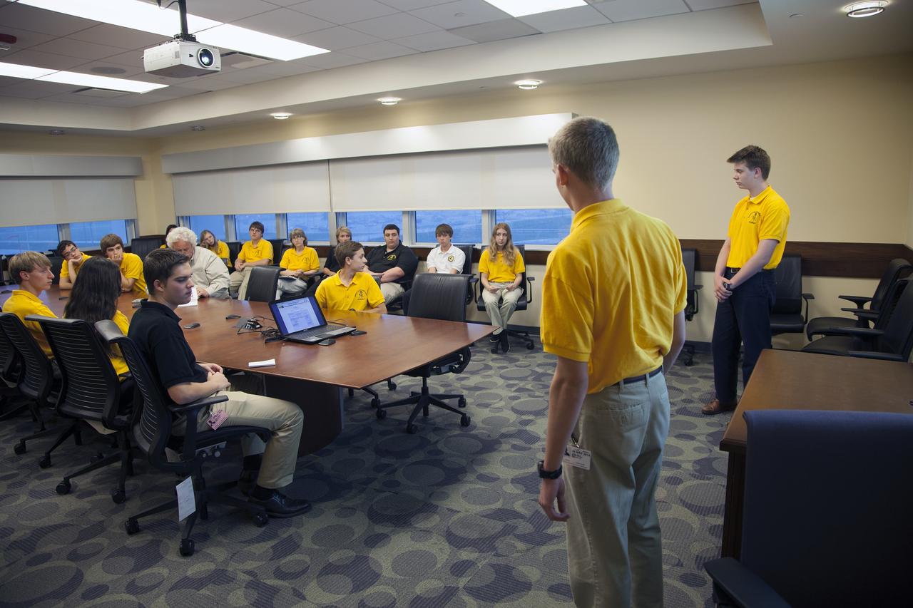 CAPE CANAVERAL, Fla. – Students representing a team from Merritt Island High School present their StangSat concepts to NASA engineers at a Critical Design Review in the Operations and Checkout Building at NASA's Kennedy Space Center in Florida.    StangSat is one of many CubeSats under development in a class of research spacecraft called nanosatellites. The cube-shaped satellites measure about 4 inches on each side, have a volume of about 1 quart and weigh less than 3 pounds. To date, 27 CubeSats have launched through the initiative as part of the agency's Launch Services Program's Educational Launch of Nanosatellite Program. This year, four separate launches will carry 17 CubeSats. To learn more about the CubeSat Launch Initiative, visit http://go.nasa.gov/CubeSat_initiative.  Photo credit: NASA/Ben Smegelsky