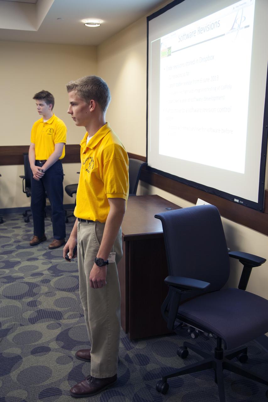 CAPE CANAVERAL, Fla. – Students representing a team from Merritt Island High School present their StangSat concepts to NASA engineers at a Critical Design Review in the Operations and Checkout Building at NASA's Kennedy Space Center in Florida.    StangSat is one of many CubeSats under development in a class of research spacecraft called nanosatellites. The cube-shaped satellites measure about 4 inches on each side, have a volume of about 1 quart and weigh less than 3 pounds. To date, 27 CubeSats have launched through the initiative as part of the agency's Launch Services Program's Educational Launch of Nanosatellite Program. This year, four separate launches will carry 17 CubeSats. To learn more about the CubeSat Launch Initiative, visit http://go.nasa.gov/CubeSat_initiative.  Photo credit: NASA/Ben Smegelsky