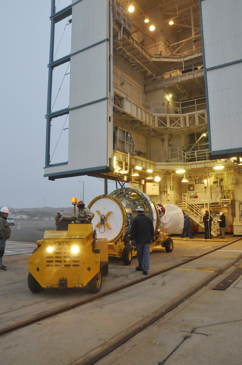 VANDENBERG AIR FORCE BASE, Calif. – The Delta II second stage for NASA's Orbiting Carbon Observatory-2 mission, or OCO-2, is towed into place at the base of the mobile service tower at Space Launch Complex 2 on Vandenberg Air Force Base in California. Operations are underway to lift the second stage into the tower.     OCO-2 is scheduled to launch aboard a United Launch Alliance Delta II rocket in July. The rocket's second stage will insert OCO-2 into a polar Earth orbit.  OCO-2 will collect precise global measurements of carbon dioxide in the Earth's atmosphere and provide scientists with a better idea of the chemical compound's impacts on climate change. Scientists will analyze this data to improve our understanding of the natural processes and human activities that regulate the abundance and distribution of this important atmospheric gas. To learn more about OCO-2, visit http://oco.jpl.nasa.gov.  Photo credit: NASA/Randy Beaudoin