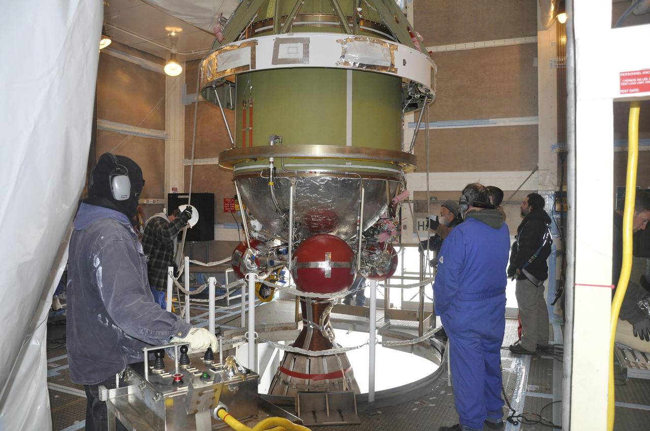 VANDENBERG AIR FORCE BASE, Calif. – Workers lower the Delta II second stage for NASA's Orbiting Carbon Observatory-2 mission, or OCO-2, into position over the rocket's first stage in the mobile service tower at Space Launch Complex 2 on Vandenberg Air Force Base in California.  Operations are underway to mate the stages for launch.     OCO-2 is scheduled to launch aboard a United Launch Alliance Delta II rocket in July. The rocket's second stage will insert OCO-2 into a polar Earth orbit.  OCO-2 will collect precise global measurements of carbon dioxide in the Earth's atmosphere and provide scientists with a better idea of the chemical compound's impacts on climate change. Scientists will analyze this data to improve our understanding of the natural processes and human activities that regulate the abundance and distribution of this important atmospheric gas. To learn more about OCO-2, visit http://oco.jpl.nasa.gov.  Photo credit: NASA/Randy Beaudoin