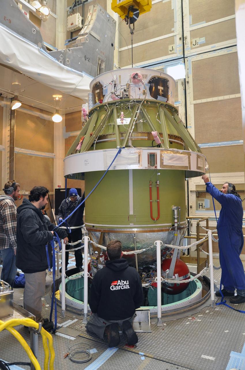 VANDENBERG AIR FORCE BASE, Calif. – Workers monitor the Delta II second stage for NASA's Orbiting Carbon Observatory-2 mission, or OCO-2, as it is lowered into position for mating with the rocket's first stage in the mobile service tower at Space Launch Complex 2 on Vandenberg Air Force Base in California.     OCO-2 is scheduled to launch aboard a United Launch Alliance Delta II rocket in July. The rocket's second stage will insert OCO-2 into a polar Earth orbit.  OCO-2 will collect precise global measurements of carbon dioxide in the Earth's atmosphere and provide scientists with a better idea of the chemical compound's impacts on climate change. Scientists will analyze this data to improve our understanding of the natural processes and human activities that regulate the abundance and distribution of this important atmospheric gas. To learn more about OCO-2, visit http://oco.jpl.nasa.gov.  Photo credit: NASA/Randy Beaudoin