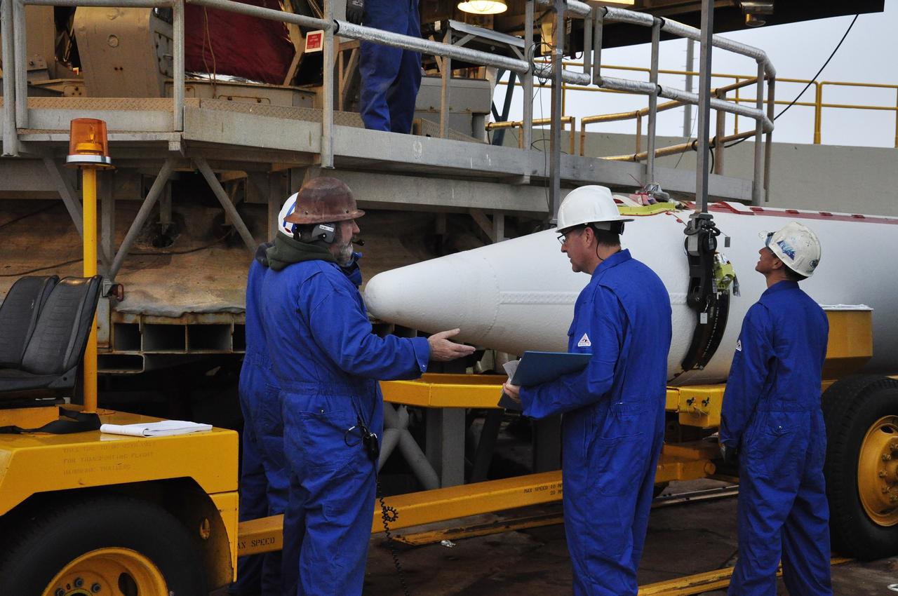 VANDENBERG AIR FORCE BASE, Calif. – Workers inspect the nosecone of a solid rocket motor, or SRM, for NASA's Orbiting Carbon Observatory-2 mission, or OCO-2, upon its delivery to the mobile service tower at Space Launch Complex 2 on Vandenberg Air Force Base in California. Operations are underway to attach the Delta II rocket's three SRMs, known as graphite epoxy motors, to the rocket's first stage. OCO-2 is scheduled to launch into a polar Earth orbit aboard a United Launch Alliance Delta II 7320-10C rocket in July. Once in orbit, OCO-2 will collect precise global measurements of carbon dioxide in the Earth's atmosphere and provide scientists with a better idea of the chemical compound's impacts on climate change. Scientists will analyze this data to improve our understanding of the natural processes and human activities that regulate the abundance and distribution of this important atmospheric gas. To learn more about OCO-2, visit http://oco.jpl.nasa.gov. Photo credit: NASA/Randy Beaudoin
