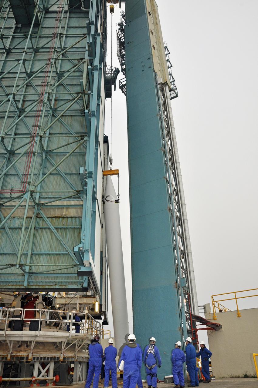 VANDENBERG AIR FORCE BASE, Calif. – Workers monitor the solid rocket motor, or SRM, for NASA's Orbiting Carbon Observatory-2 mission, or OCO-2, as it is lifted into a vertical position beside the mobile service tower at Space Launch Complex 2 on Vandenberg Air Force Base in California. Operations are underway to attach the Delta II rocket's three SRMs, known as graphite epoxy motors, to the rocket's first stage. OCO-2 is scheduled to launch into a polar Earth orbit aboard a United Launch Alliance Delta II 7320-10C rocket in July. Once in orbit, OCO-2 will collect precise global measurements of carbon dioxide in the Earth's atmosphere and provide scientists with a better idea of the chemical compound's impacts on climate change. Scientists will analyze this data to improve our understanding of the natural processes and human activities that regulate the abundance and distribution of this important atmospheric gas. To learn more about OCO-2, visit http://oco.jpl.nasa.gov. Photo credit: NASA/Randy Beaudoin