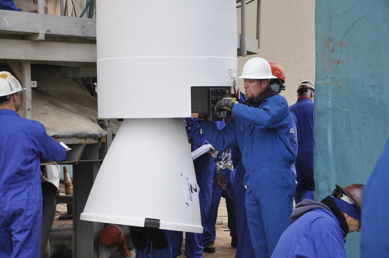 VANDENBERG AIR FORCE BASE, Calif. – A worker inspects the solid rocket motor, or SRM, for NASA's Orbiting Carbon Observatory-2 mission, or OCO-2, after it is lifted into a vertical position beside the mobile service tower at Space Launch Complex 2 on Vandenberg Air Force Base in California. Operations are underway to attach the Delta II rocket's three SRMs, known as graphite epoxy motors, to the rocket's first stage. OCO-2 is scheduled to launch into a polar Earth orbit aboard a United Launch Alliance Delta II 7320-10C rocket in July. Once in orbit, OCO-2 will collect precise global measurements of carbon dioxide in the Earth's atmosphere and provide scientists with a better idea of the chemical compound's impacts on climate change. Scientists will analyze this data to improve our understanding of the natural processes and human activities that regulate the abundance and distribution of this important atmospheric gas. To learn more about OCO-2, visit http://oco.jpl.nasa.gov. Photo credit: NASA/Randy Beaudoin
