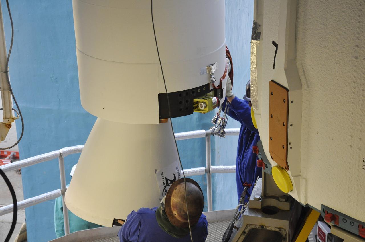VANDENBERG AIR FORCE BASE, Calif. – Workers monitor the solid rocket motor, or SRM, for NASA's Orbiting Carbon Observatory-2 mission, or OCO-2, as it moves into position beside the Delta II first stage in the mobile service tower at Space Launch Complex 2 on Vandenberg Air Force Base in California. Operations are underway to attach the Delta II rocket's three SRMs, known as graphite epoxy motors, to the rocket's first stage.      OCO-2 is scheduled to launch into a polar Earth orbit aboard a United Launch Alliance Delta II 7320-10C rocket in July. Once in orbit, OCO-2 will collect precise global measurements of carbon dioxide in the Earth's atmosphere and provide scientists with a better idea of the chemical compound's impacts on climate change. Scientists will analyze this data to improve our understanding of the natural processes and human activities that regulate the abundance and distribution of this important atmospheric gas. To learn more about OCO-2, visit http://oco.jpl.nasa.gov.  Photo credit: NASA/Randy Beaudoin