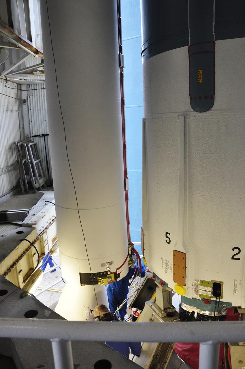 VANDENBERG AIR FORCE BASE, Calif. – A worker attaches a solid rocket motor, or SRM, for NASA's Orbiting Carbon Observatory-2 mission, or OCO-2, to the Delta II first stage in the mobile service tower at Space Launch Complex 2 on Vandenberg Air Force Base in California. Operations are underway to attach the rocket's three SRMs, known as graphite epoxy motors, to its first stage.      OCO-2 is scheduled to launch into a polar Earth orbit aboard a United Launch Alliance Delta II 7320-10C rocket in July. Once in orbit, OCO-2 will collect precise global measurements of carbon dioxide in the Earth's atmosphere and provide scientists with a better idea of the chemical compound's impacts on climate change. Scientists will analyze this data to improve our understanding of the natural processes and human activities that regulate the abundance and distribution of this important atmospheric gas. To learn more about OCO-2, visit http://oco.jpl.nasa.gov.  Photo credit: NASA/Randy Beaudoin