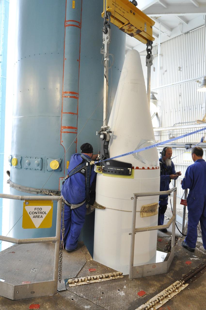 VANDENBERG AIR FORCE BASE, Calif. – Workers complete the task of attaching a solid rocket motor, or SRM, for NASA's Orbiting Carbon Observatory-2 mission, or OCO-2, to the Delta II first stage in the mobile service tower at Space Launch Complex 2 on Vandenberg Air Force Base in California. Operations are underway to attach the rocket's three SRMs, known as graphite epoxy motors, to its first stage.      OCO-2 is scheduled to launch into a polar Earth orbit aboard a United Launch Alliance Delta II 7320-10C rocket in July. Once in orbit, OCO-2 will collect precise global measurements of carbon dioxide in the Earth's atmosphere and provide scientists with a better idea of the chemical compound's impacts on climate change. Scientists will analyze this data to improve our understanding of the natural processes and human activities that regulate the abundance and distribution of this important atmospheric gas. To learn more about OCO-2, visit http://oco.jpl.nasa.gov.  Photo credit: NASA/Randy Beaudoin