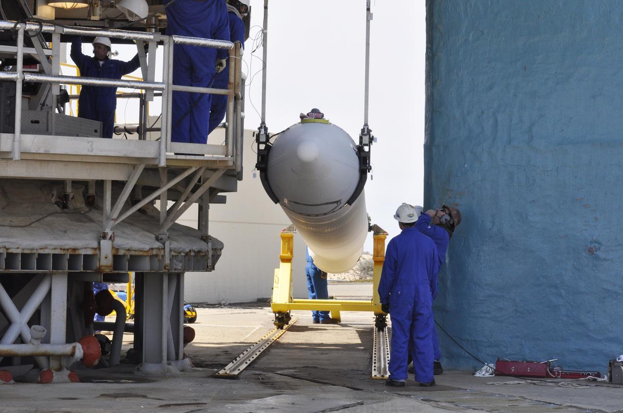 VANDENBERG AIR FORCE BASE, Calif. – Workers monitor the second solid rocket motor, or SRM, for NASA's Orbiting Carbon Observatory-2 mission, or OCO-2, as it is lifted into a vertical position beside the mobile service tower at Space Launch Complex 2 on Vandenberg Air Force Base in California. Operations are underway to attach the Delta II rocket's three SRMs, known as graphite epoxy motors, to its first stage. OCO-2 is scheduled to launch into a polar Earth orbit aboard a United Launch Alliance Delta II 7320-10C rocket in July. Once in orbit, OCO-2 will collect precise global measurements of carbon dioxide in the Earth's atmosphere and provide scientists with a better idea of the chemical compound's impacts on climate change. Scientists will analyze this data to improve our understanding of the natural processes and human activities that regulate the abundance and distribution of this important atmospheric gas. To learn more about OCO-2, visit http://oco.jpl.nasa.gov. Photo credit: NASA/Randy Beaudoin