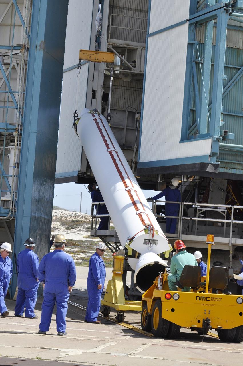 VANDENBERG AIR FORCE BASE, Calif. – A crane lifts the second solid rocket motor, or SRM, for NASA's Orbiting Carbon Observatory-2 mission, or OCO-2, into a vertical position beside the mobile service tower at Space Launch Complex 2 on Vandenberg Air Force Base in California. Operations are underway to attach the Delta II rocket's three SRMs, known as graphite epoxy motors, to its first stage. OCO-2 is scheduled to launch into a polar Earth orbit aboard a United Launch Alliance Delta II 7320-10C rocket in July. Once in orbit, OCO-2 will collect precise global measurements of carbon dioxide in the Earth's atmosphere and provide scientists with a better idea of the chemical compound's impacts on climate change. Scientists will analyze this data to improve our understanding of the natural processes and human activities that regulate the abundance and distribution of this important atmospheric gas. To learn more about OCO-2, visit http://oco.jpl.nasa.gov. Photo credit: NASA/Randy Beaudoin