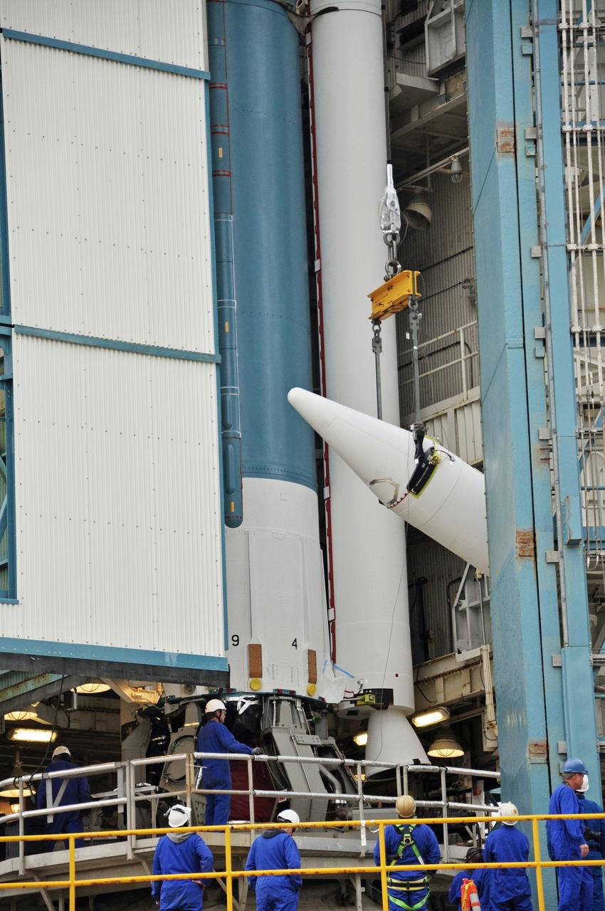VANDENBERG AIR FORCE BASE, Calif. – Workers monitor the third solid rocket motor, or SRM, for NASA's Orbiting Carbon Observatory-2 mission, or OCO-2, as it is lifted into a vertical position beside the Delta II first stage in the mobile service tower at Space Launch Complex 2 on Vandenberg Air Force Base in California. Operations are underway to attach the Delta II rocket's three SRMs, known as graphite epoxy motors, to its first stage.     OCO-2 is scheduled to launch into a polar Earth orbit aboard a United Launch Alliance Delta II 7320-10C rocket in July. Once in orbit, OCO-2 will collect precise global measurements of carbon dioxide in the Earth's atmosphere and provide scientists with a better idea of the chemical compound's impacts on climate change. Scientists will analyze this data to improve our understanding of the natural processes and human activities that regulate the abundance and distribution of this important atmospheric gas. To learn more about OCO-2, visit http://oco.jpl.nasa.gov.  Photo credit: NASA/Randy Beaudoin