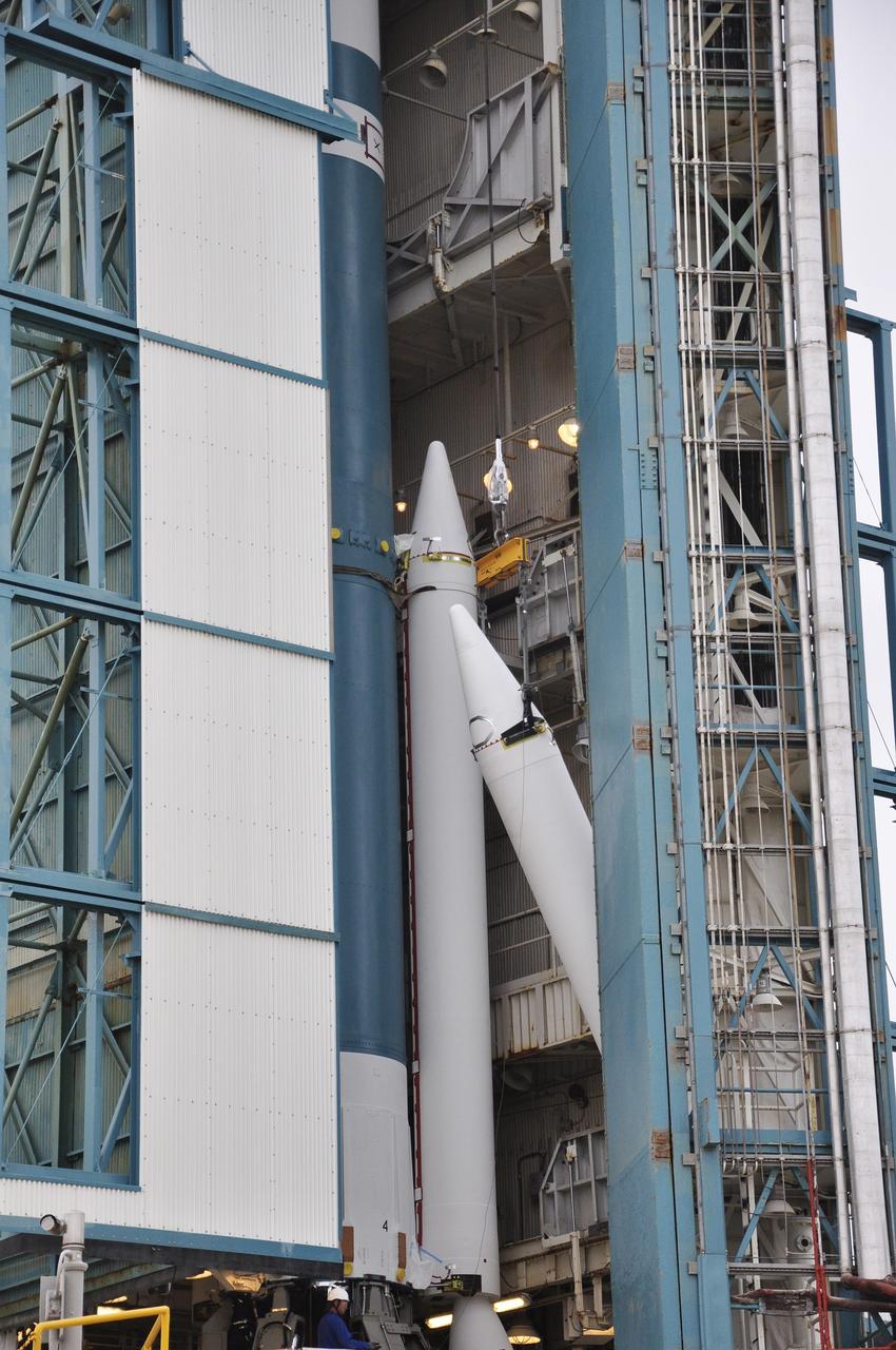 VANDENBERG AIR FORCE BASE, Calif. – The third solid rocket motor, or SRM, for NASA's Orbiting Carbon Observatory-2 mission, or OCO-2, is lifted into place beside the Delta II first stage, with two SRMs already attached, in the mobile service tower at Space Launch Complex 2 on Vandenberg Air Force Base in California. Operations are underway to attach the rocket's three SRMs, known as graphite epoxy motors, to its first stage.      OCO-2 is scheduled to launch into a polar Earth orbit aboard a United Launch Alliance Delta II 7320-10C rocket in July. Once in orbit, OCO-2 will collect precise global measurements of carbon dioxide in the Earth's atmosphere and provide scientists with a better idea of the chemical compound's impacts on climate change. Scientists will analyze this data to improve our understanding of the natural processes and human activities that regulate the abundance and distribution of this important atmospheric gas. To learn more about OCO-2, visit http://oco.jpl.nasa.gov.  Photo credit: NASA/Randy Beaudoin
