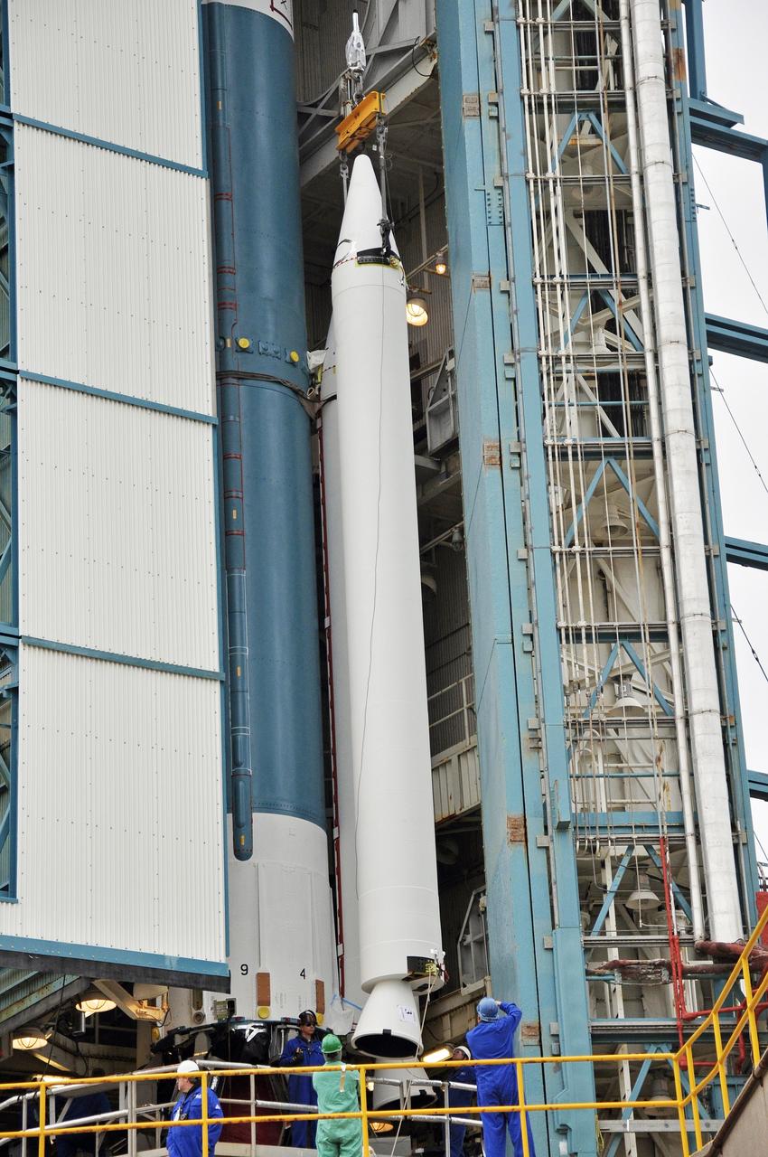 VANDENBERG AIR FORCE BASE, Calif. – Workers monitor the third solid rocket motor, or SRM, for NASA's Orbiting Carbon Observatory-2 mission, or OCO-2, as it moves into position beside the Delta II first stage in the mobile service tower at Space Launch Complex 2 on Vandenberg Air Force Base in California. Operations are underway to attach the rocket's three SRMs, known as graphite epoxy motors, to its first stage.      OCO-2 is scheduled to launch into a polar Earth orbit aboard a United Launch Alliance Delta II 7320-10C rocket in July. Once in orbit, OCO-2 will collect precise global measurements of carbon dioxide in the Earth's atmosphere and provide scientists with a better idea of the chemical compound's impacts on climate change. Scientists will analyze this data to improve our understanding of the natural processes and human activities that regulate the abundance and distribution of this important atmospheric gas. To learn more about OCO-2, visit http://oco.jpl.nasa.gov.  Photo credit: NASA/Randy Beaudoin