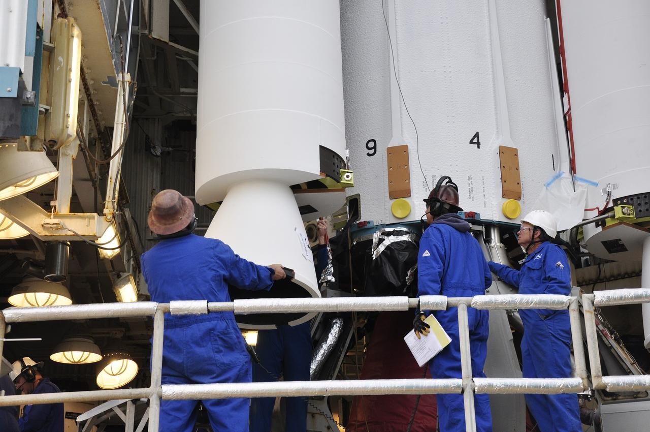 VANDENBERG AIR FORCE BASE, Calif. – Workers attach a third solid rocket motor, or SRM, for NASA's Orbiting Carbon Observatory-2 mission, or OCO-2, to the Delta II first stage in the mobile service tower at Space Launch Complex 2 on Vandenberg Air Force Base in California. Operations to attach the rocket's three SRMs, known as graphite epoxy motors, to its first stage are nearing completion.      OCO-2 is scheduled to launch into a polar Earth orbit aboard a United Launch Alliance Delta II 7320-10C rocket in July. Once in orbit, OCO-2 will collect precise global measurements of carbon dioxide in the Earth's atmosphere and provide scientists with a better idea of the chemical compound's impacts on climate change. Scientists will analyze this data to improve our understanding of the natural processes and human activities that regulate the abundance and distribution of this important atmospheric gas. To learn more about OCO-2, visit http://oco.jpl.nasa.gov.  Photo credit: NASA/Randy Beaudoin