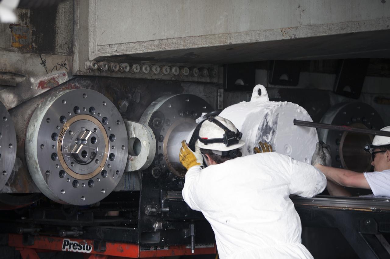 CAPE CANAVERAL, Fla. - Inside the Vehicle Assembly Building at NASA’s Kennedy Space Center in Florida, ground support technicians install a new roller bearing shaft on the C truck of crawler-transporter 2, or CT-2.     Work continues in high bay 2 to upgrade CT-2. The modifications are designed to ensure CT-2’s ability to transport launch vehicles currently in development, such as the agency’s Space Launch System, to the launch pad. The Ground Systems Development and Operations Program office at Kennedy is overseeing the upgrades. For more than 45 years the crawler-transporters were used to transport the mobile launcher platform and the Apollo-Saturn V rockets and, later, space shuttles to Launch Pads 39A and B. For more information, visit: http://www.nasa.gov/exploration/systems/ground/crawler-transporter. Photo credit: NASA/Dimitri Gerondidakis