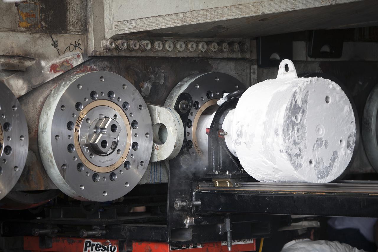 CAPE CANAVERAL, Fla. - Inside the Vehicle Assembly Building at NASA’s Kennedy Space Center in Florida, a new roller bearing shaft is being inserted in the C truck of crawler-transporter 2, or CT-2.      Work continues in high bay 2 to upgrade CT-2. The modifications are designed to ensure CT-2’s ability to transport launch vehicles currently in development, such as the agency’s Space Launch System, to the launch pad. The Ground Systems Development and Operations Program office at Kennedy is overseeing the upgrades. For more than 45 years the crawler-transporters were used to transport the mobile launcher platform and the Apollo-Saturn V rockets and, later, space shuttles to Launch Pads 39A and B. For more information, visit: http://www.nasa.gov/exploration/systems/ground/crawler-transporter. Photo credit: NASA/Dimitri Gerondidakis