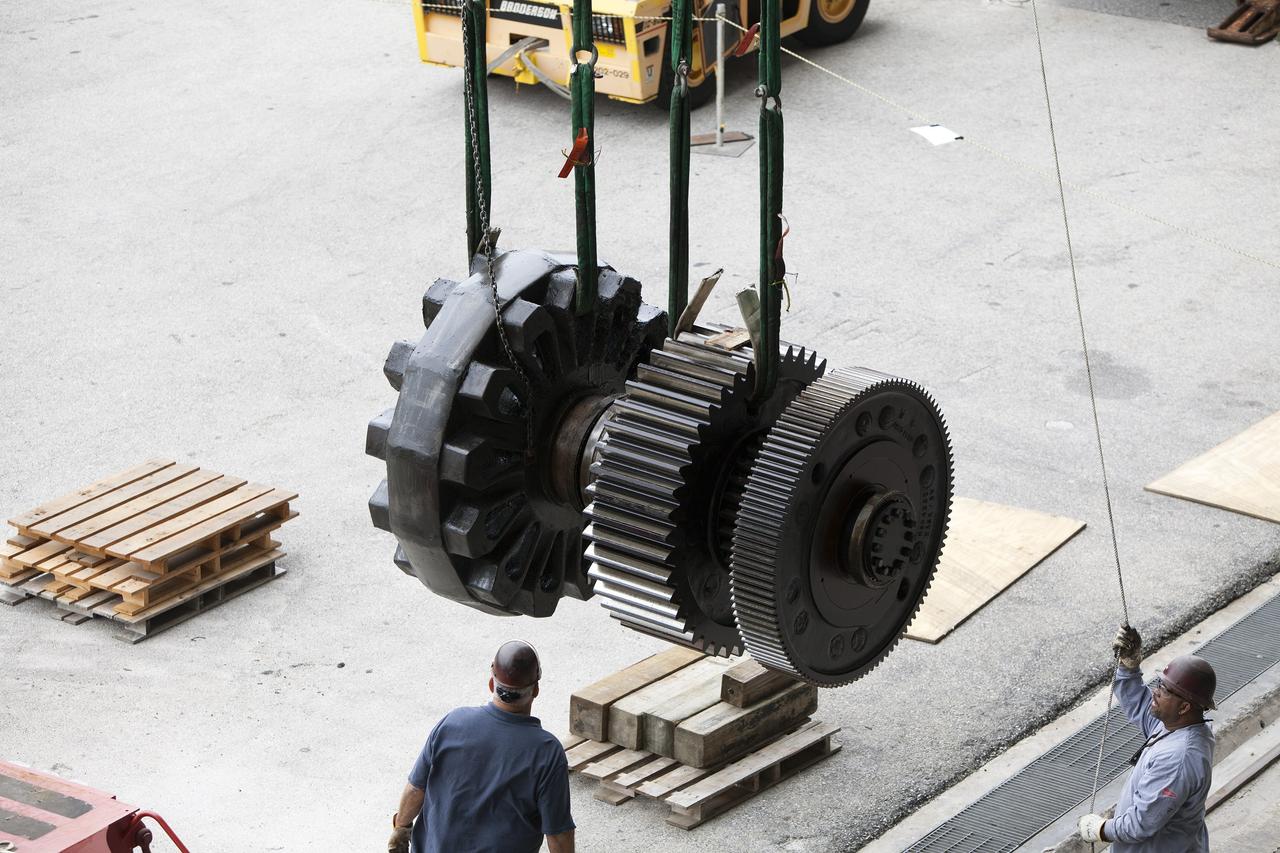 CAPE CANAVERAL, Fla. - Inside the Vehicle Assembly Building at NASA’s Kennedy Space Center in Florida, ground support technicians monitor the progress as an overhead crane moves one of the sprocket shaft assemblies away from the C truck of crawler-transporter 2, or CT-2. The sprocket assemblies will be placed into shipping cradles on pallets and positioned on a flatbed trailer. They will be sent to a vendor for inspections and refurbishment.     Work continues in high bay 2 to upgrade CT-2. The modifications are designed to ensure CT-2’s ability to transport launch vehicles currently in development, such as the agency’s Space Launch System, to the launch pad. The Ground Systems Development and Operations Program office at Kennedy is overseeing the upgrades. For more than 45 years the crawler-transporters were used to transport the mobile launcher platform and the Apollo-Saturn V rockets and, later, space shuttles to Launch Pads 39A and B. For more information, visit: http://www.nasa.gov/exploration/systems/ground/crawler-transporter. Photo credit: NASA/Dimitri Gerondidakis