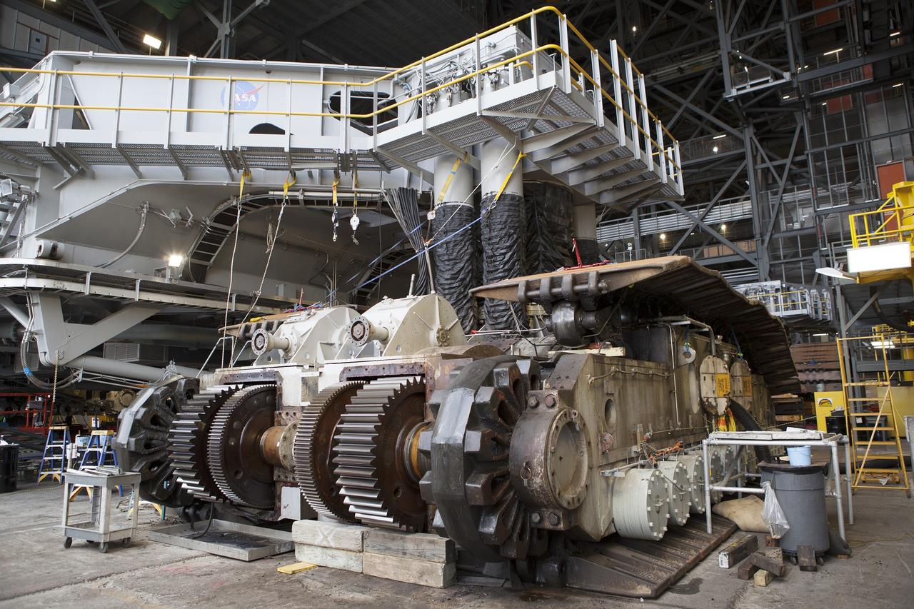 CAPE CANAVERAL, Fla. - Inside the Vehicle Assembly Building at NASA’s Kennedy Space Center in Florida, work continues to remove the sprocket shaft assembly from the C truck of crawler-transporter 2, or CT-2. The sprocket assemblies will be placed into shipping cradles on pallets and positioned on a flatbed trailer. They will be sent to a vendor for inspections and refurbishment.     Work continues in high bay 2 to upgrade CT-2. The modifications are designed to ensure CT-2’s ability to transport launch vehicles currently in development, such as the agency’s Space Launch System, to the launch pad. The Ground Systems Development and Operations Program office at Kennedy is overseeing the upgrades. For more than 45 years the crawler-transporters were used to transport the mobile launcher platform and the Apollo-Saturn V rockets and, later, space shuttles to Launch Pads 39A and B. For more information, visit: http://www.nasa.gov/exploration/systems/ground/crawler-transporter. Photo credit: NASA/Dimitri Gerondidakis