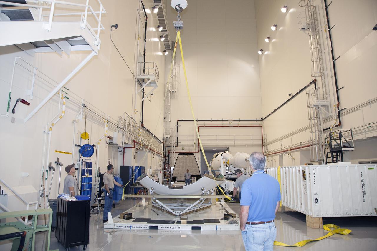 CAPE CANAVERAL, Fla. - The first set of two Ogive panels for the Orion Launch Abort System was uncrated inside the Launch Abort System Facility, or LASF, at NASA’s Kennedy Space Center in Florida. One of the panels has been secured on a stand at the far end of the facility. Technicians assist as a crane is attached to the second panel for lifting and moving to the storage stand. During processing, the panels will be secured around the Orion crew module and attached to the Launch Abort System.      Orion is the exploration spacecraft designed to carry astronauts to destinations not yet explored by humans, including an asteroid and Mars. It will have emergency abort capability, sustain the crew during space travel and provide safe re-entry from deep space return velocities. The first unpiloted test flight of Orion is scheduled to launch in 2014 atop a Delta IV rocket and in 2017 on NASA’s Space Launch System rocket. For more information, visit www.nasa.gov/orion. Photo credit: Dan Casper