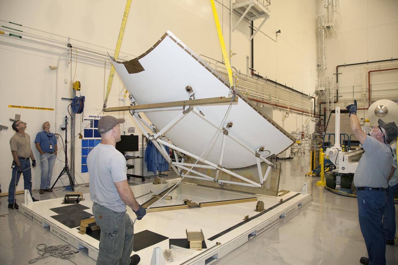 CAPE CANAVERAL, Fla. - The first set of two Ogive panels for the Orion Launch Abort System was uncrated inside the Launch Abort System Facility, or LASF, at NASA’s Kennedy Space Center in Florida. One of the panels has been secured on a stand at the far end of the facility. Technicians monitor the progress as a crane lifts the second panel to move it to the storage stand. During processing, the panels will be secured around the Orion crew module and attached to the Launch Abort System.    Orion is the exploration spacecraft designed to carry astronauts to destinations not yet explored by humans, including an asteroid and Mars. It will have emergency abort capability, sustain the crew during space travel and provide safe re-entry from deep space return velocities. The first unpiloted test flight of Orion is scheduled to launch in 2014 atop a Delta IV rocket and in 2017 on NASA’s Space Launch System rocket. For more information, visit www.nasa.gov/orion. Photo credit: Dan Casper