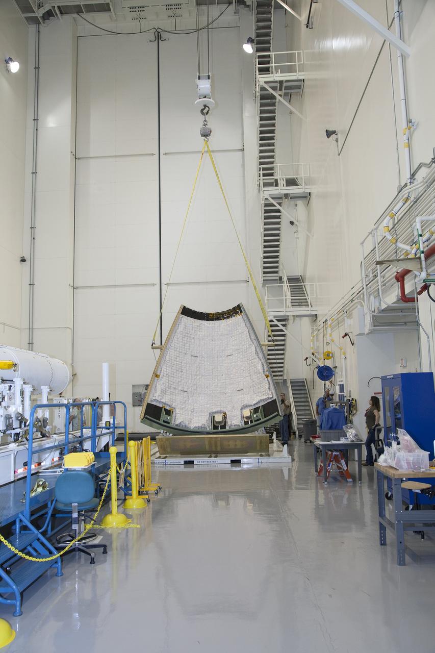 CAPE CANAVERAL, Fla. - The first set of two Ogive panels for the Orion Launch Abort System was uncrated inside the Launch Abort System Facility, or LASF, at NASA’s Kennedy Space Center in Florida. One of the panels is being lifted by crane for the move to a storage stand at the other end of the facility. During processing, the panels will be secured around the Orion crew module and attached to the Launch Abort System. Orion is the exploration spacecraft designed to carry astronauts to destinations not yet explored by humans, including an asteroid and Mars. It will have emergency abort capability, sustain the crew during space travel and provide safe re-entry from deep space return velocities. The first unpiloted test flight of Orion is scheduled to launch in 2014 atop a Delta IV rocket and in 2017 on NASA’s Space Launch System rocket. For more information, visit www.nasa.gov/orion. Photo credit: Dan Casper