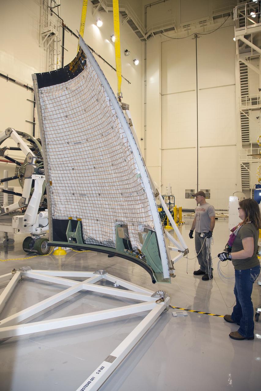 CAPE CANAVERAL, Fla. - The first set of two Ogive panels for the Orion Launch Abort System was uncrated inside the Launch Abort System Facility, or LASF, at NASA’s Kennedy Space Center in Florida. The second panel is being lifted by crane and technicians are monitoring the progress as it is being moved to join the first panel on the storage stand. During processing, the panels will be secured around the Orion crew module and attached to the Launch Abort System.    Orion is the exploration spacecraft designed to carry astronauts to destinations not yet explored by humans, including an asteroid and Mars. It will have emergency abort capability, sustain the crew during space travel and provide safe re-entry from deep space return velocities. The first unpiloted test flight of Orion is scheduled to launch in 2014 atop a Delta IV rocket and in 2017 on NASA’s Space Launch System rocket. For more information, visit www.nasa.gov/orion. Photo credit: Dan Casper