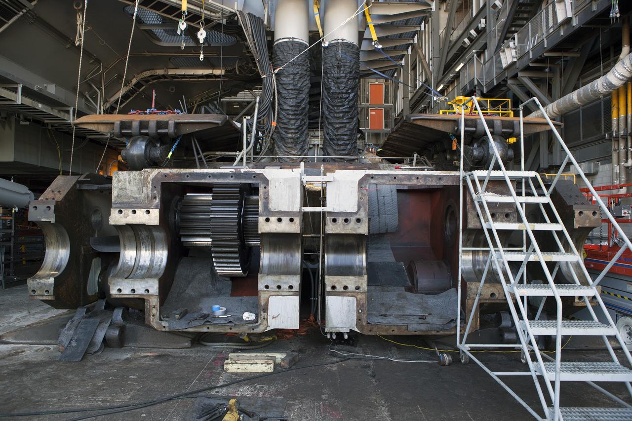 CAPE CANAVERAL, Fla. -- Inside the Vehicle Assembly Building at NASA’s Kennedy Space Center in Florida, several of the sprocket shaft assemblies have been removed from the C truck of crawler-transporter 2, or CT-2. Preparations are underway to remove the remaining sprocket. The sprocket assemblies will be placed into shipping cradles on pallets and positioned on a flatbed trailer. They will be sent to a vendor for inspections and refurbishment.    Work continues in high bay 2 to upgrade CT-2. The modifications are designed to ensure CT-2’s ability to transport launch vehicles currently in development, such as the agency’s Space Launch System, to the launch pad. The Ground Systems Development and Operations Program office at Kennedy is overseeing the upgrades. For more than 45 years the crawler-transporters were used to transport the mobile launcher platform and the Apollo-Saturn V rockets and, later, space shuttles to Launch Pads 39A and B. For more information, visit: http://www.nasa.gov/exploration/systems/ground/crawler-transporter. Photo credit: NASA/Dimitri Gerondidakis